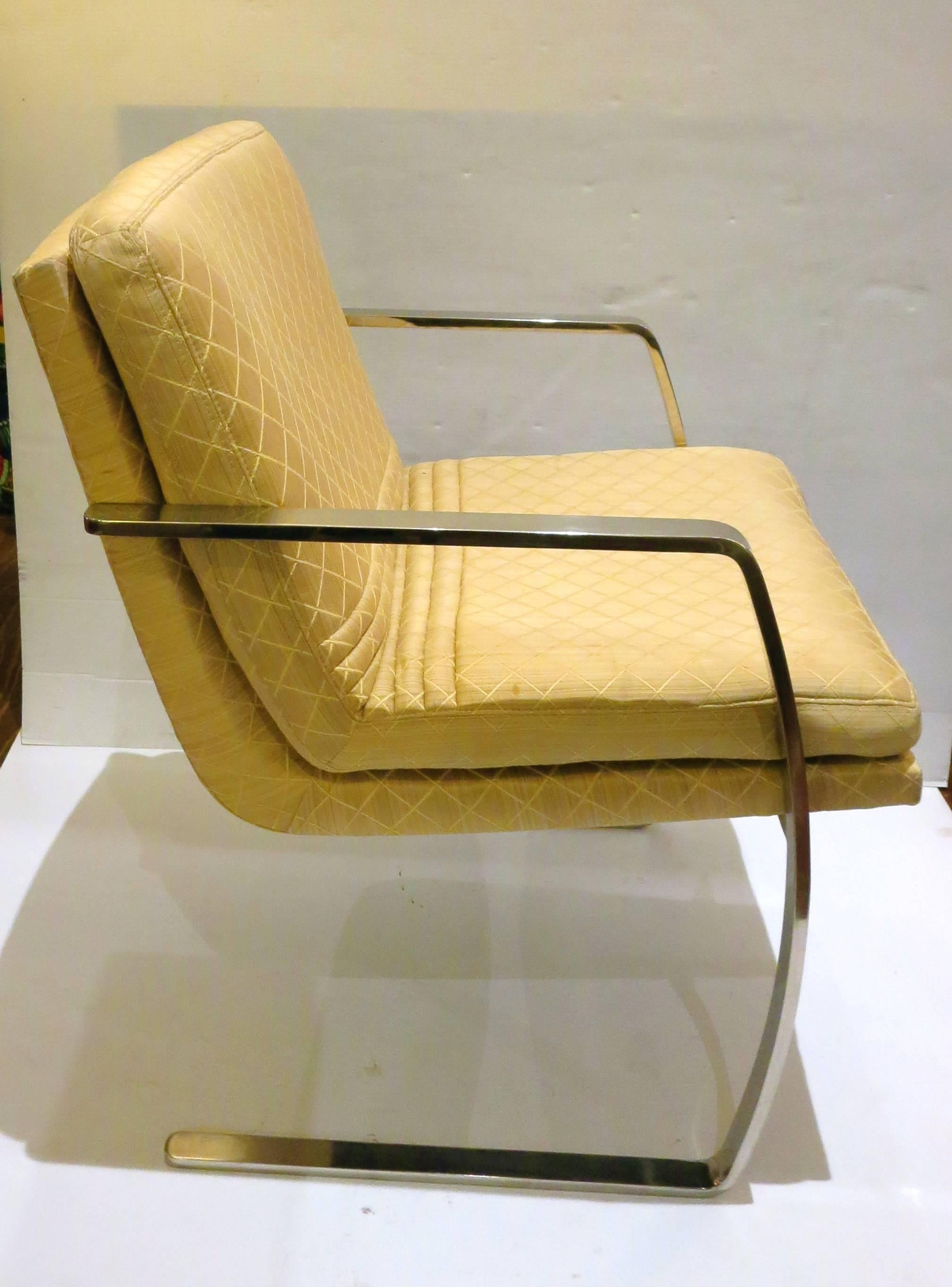 Nice cantilever armchairs, circa 1960s solid polished stainless steel, arms with original light yellow silky fabric, very nice and comfy, four available sold individually, buyer has the choice to buy 1or 2, only 2 available. the material its clean