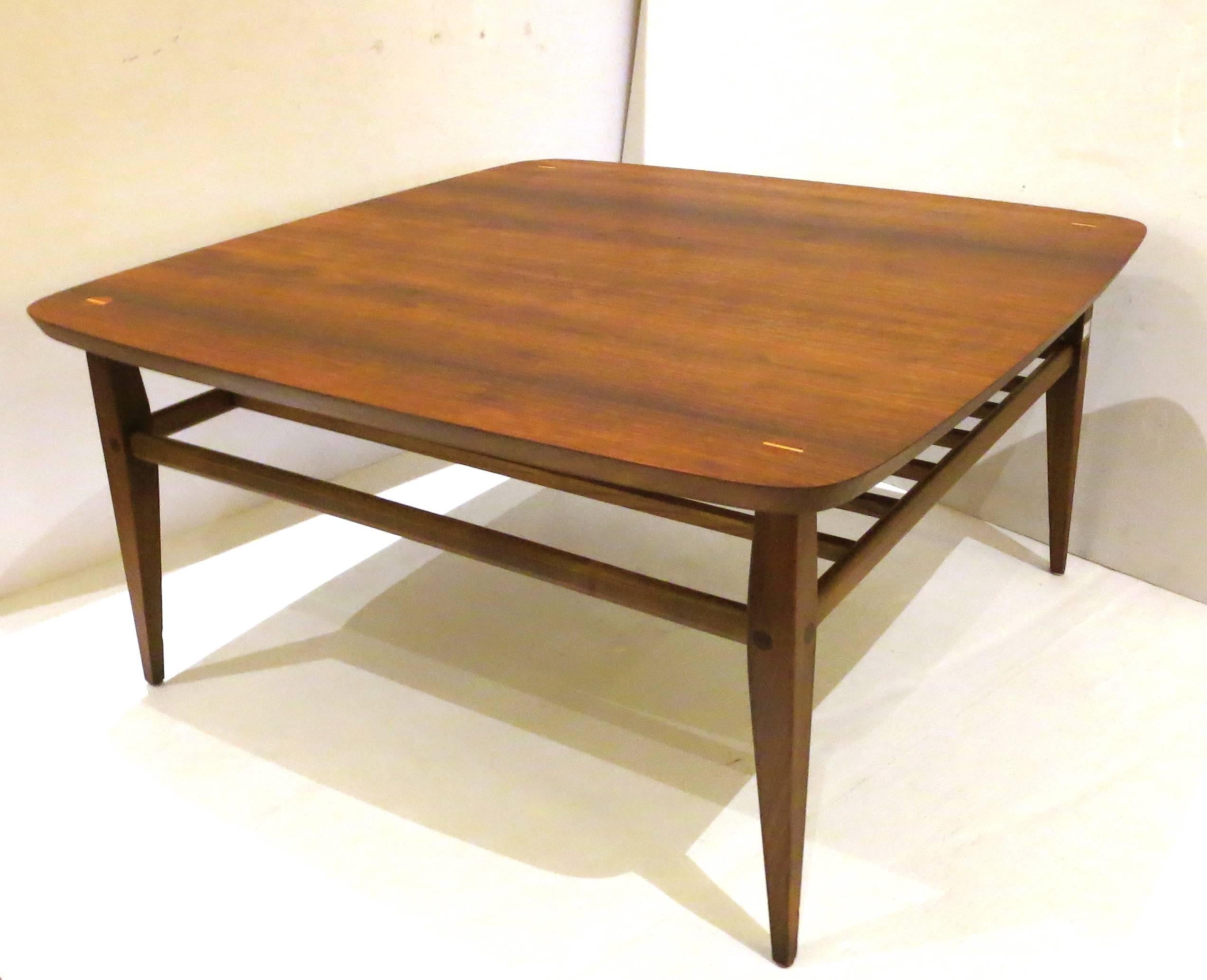 Striking beautiful walnut square coffee table with rounded corners and inlaid decorations on the top, the table circa 1960s the top has been refinished and left its hand rubbed oil finish, the base its solid and sturdy and very nice and clean