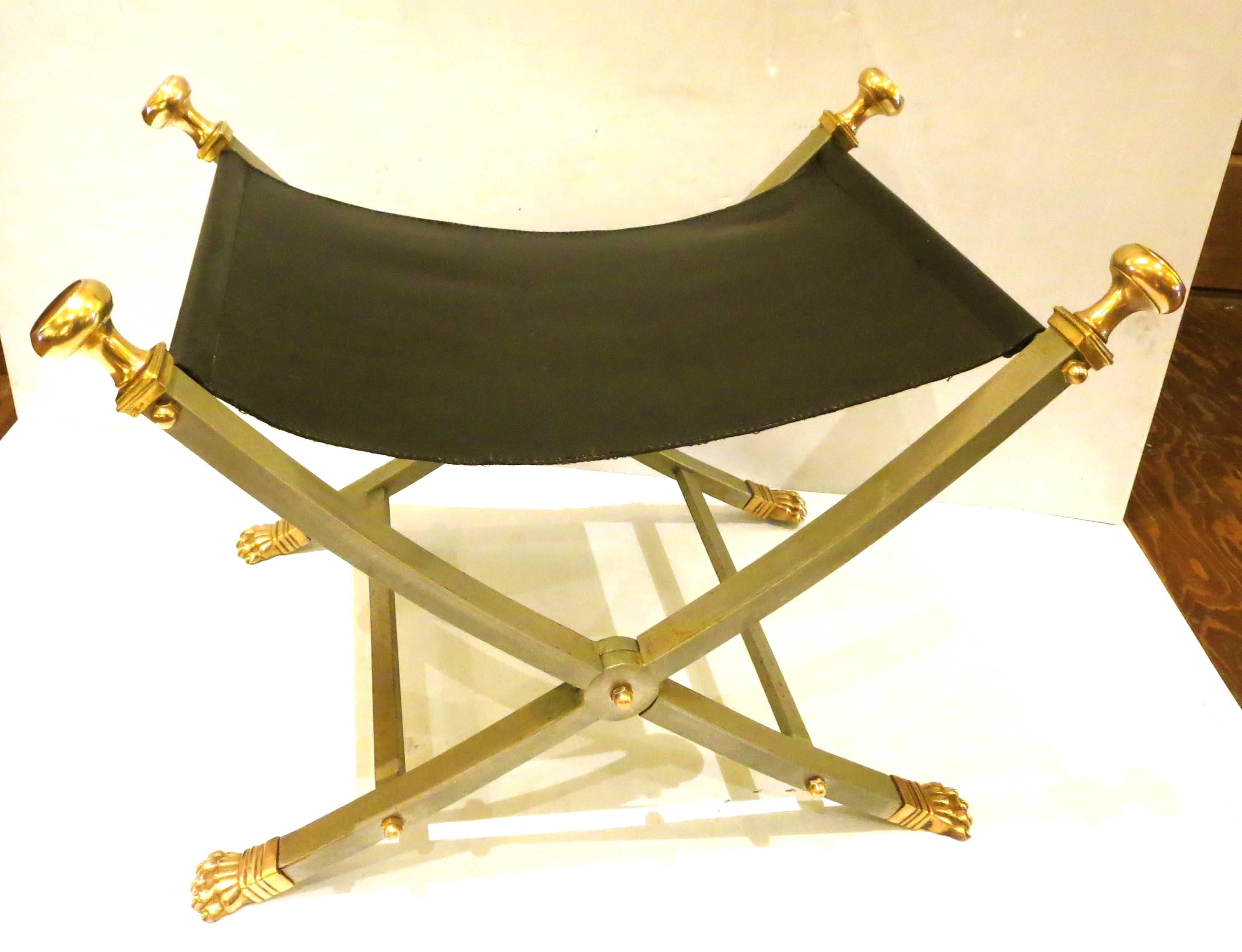 Elegant striking folding stool by Maison Jansen Brushed nickel over steel frame with brass paw feet and finials. Stamped Italy on underside of feet. Appears in the books: Jansen: Decoration, editor Jean Leveque, ppg 132-133. Les Decorateurs des