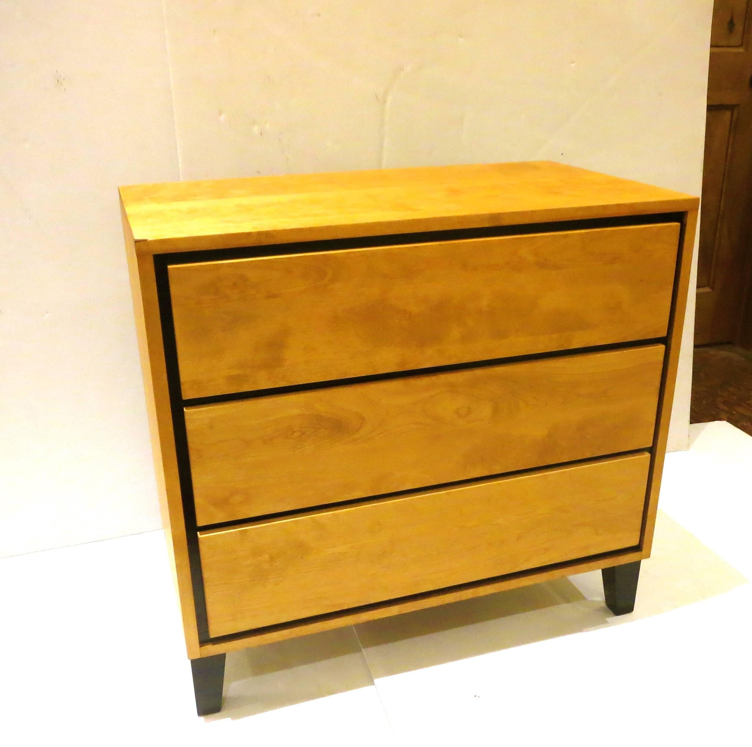 Simple elegant small triple dresser designed by Russel Wright for Conant Ball furniture, nice and solid birch wood freshly refinished and with black accents, on legs and around the drawers, well built American furniture, designed to last forever.