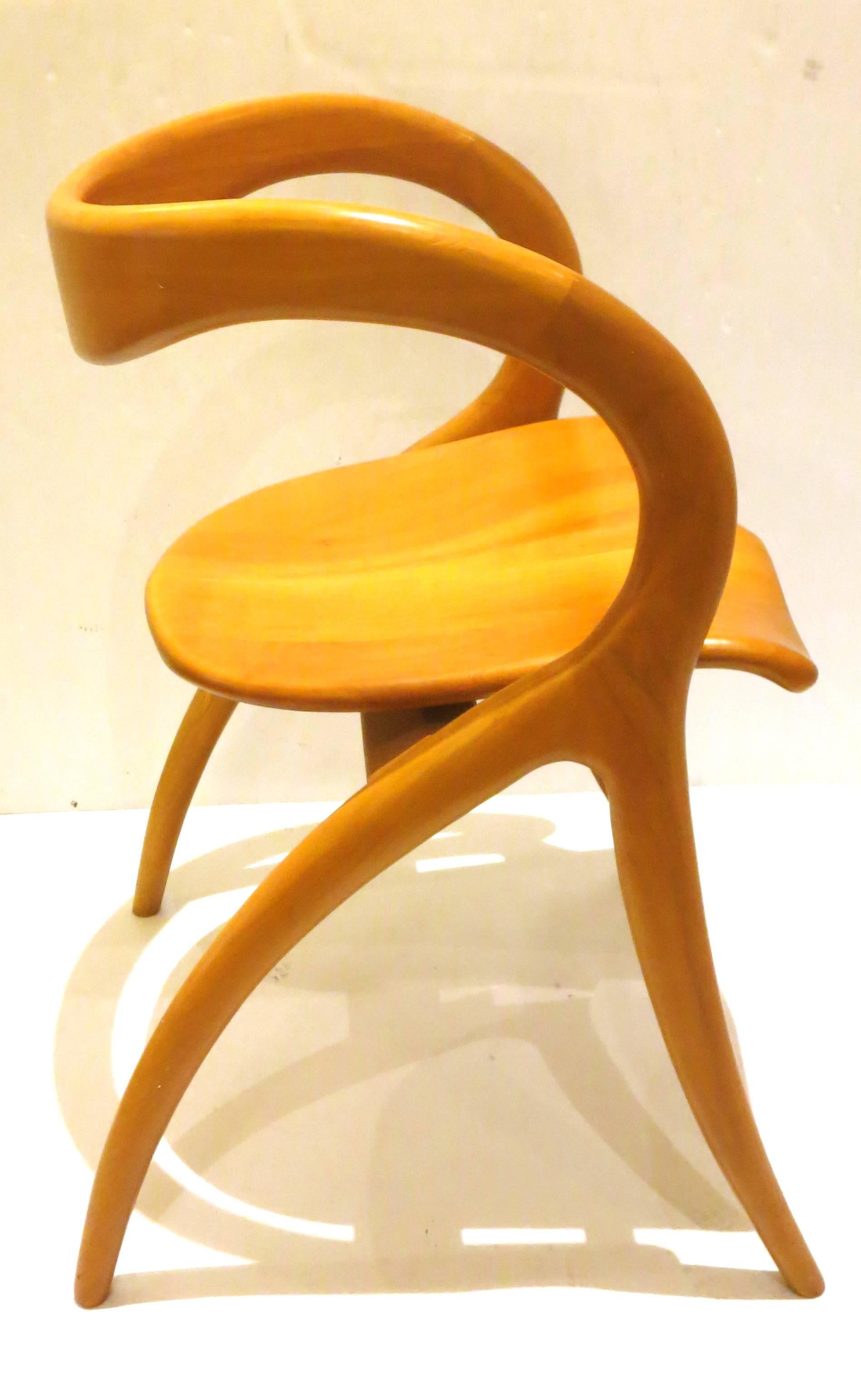 Beautiful lines on this amazing wood sculpted chair by A Sibau, made in Italy, circa 1980s. The chair its solid and sturdy with scuffs and marks as shown, part of the clear coat finish came off as shown, only on the area is shown, very sexy lines a