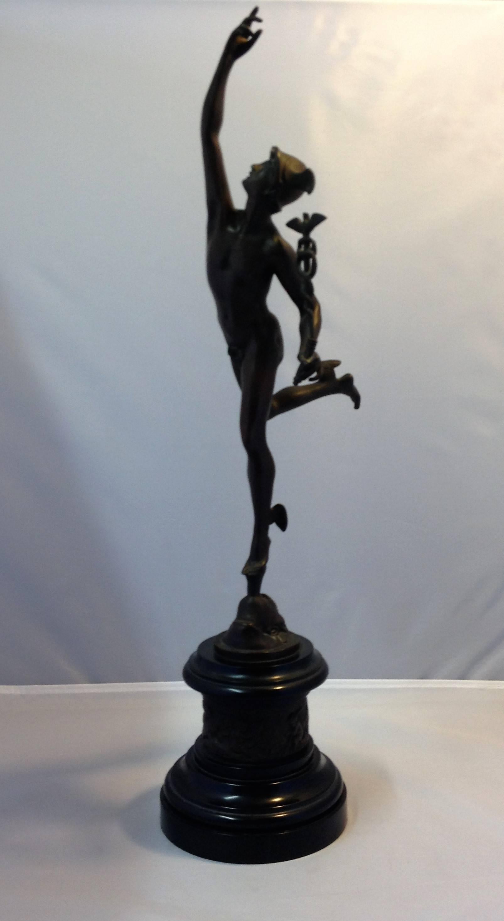 Wonderful 19th century bronze renaissance style figure of mercury (after a model by Giambologna) with a classic brownish patina. Mercury stands atop a bronze and black marble base with frieze of cherubs and figures holding a caduceus. Bronze is