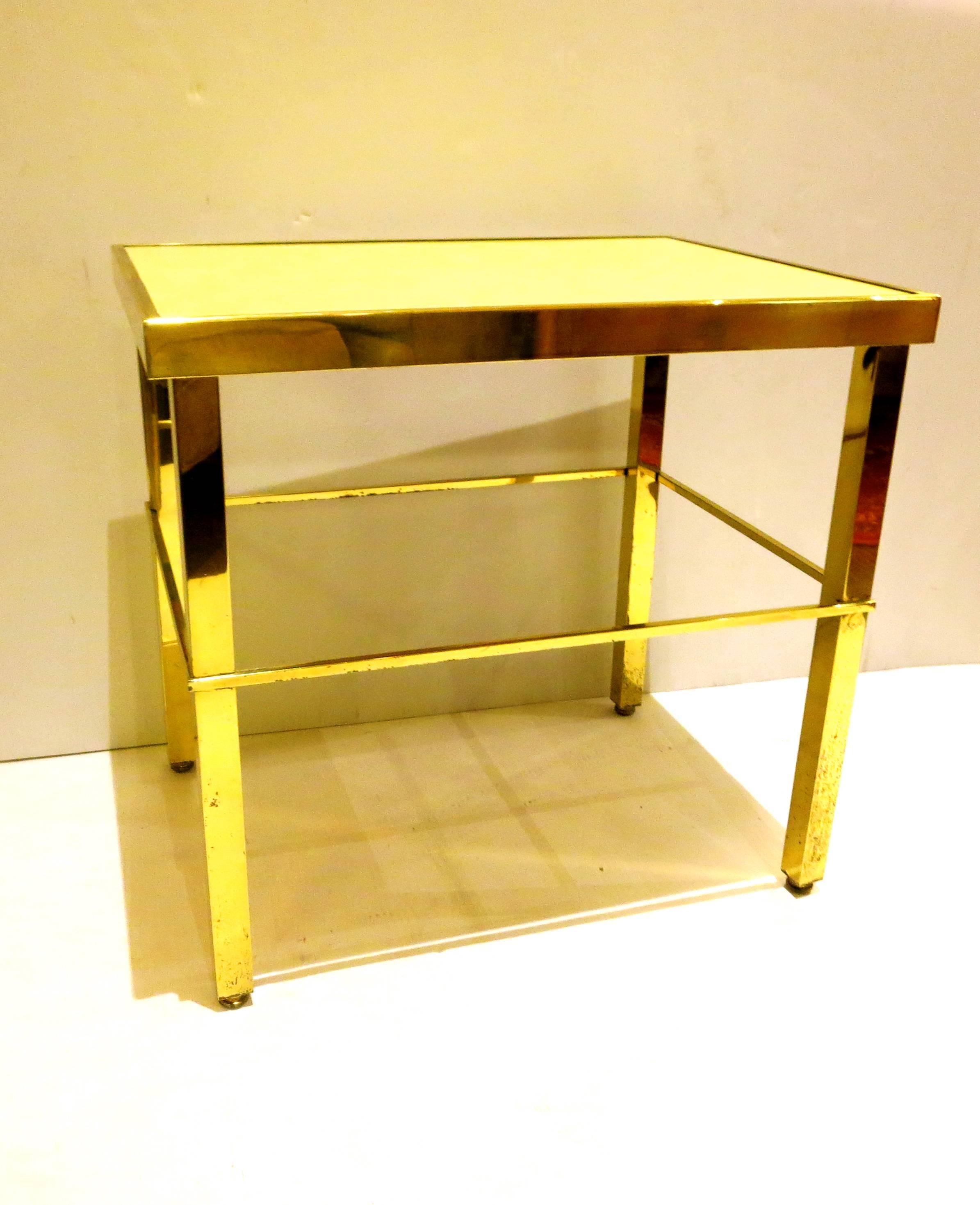 Elegant versatile brass small end cocktail table, with yellow laminated top. Incredible quality and construction, circa 1950s polished brass with some patina.