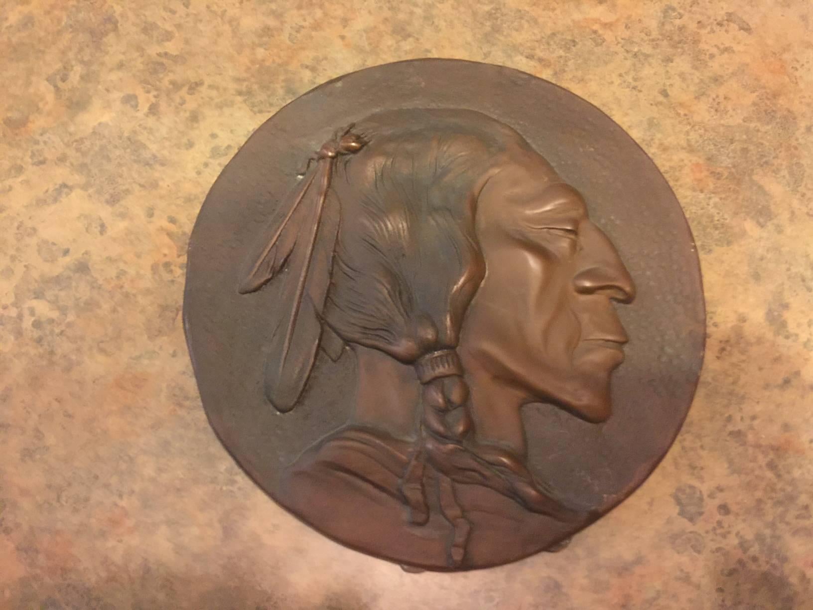 Very unique bronze plaque with stand resembling the Indian head buffalo nickel created by James Earle Fraser. The piece is 8.5" in diameter and has a wonderful patina.