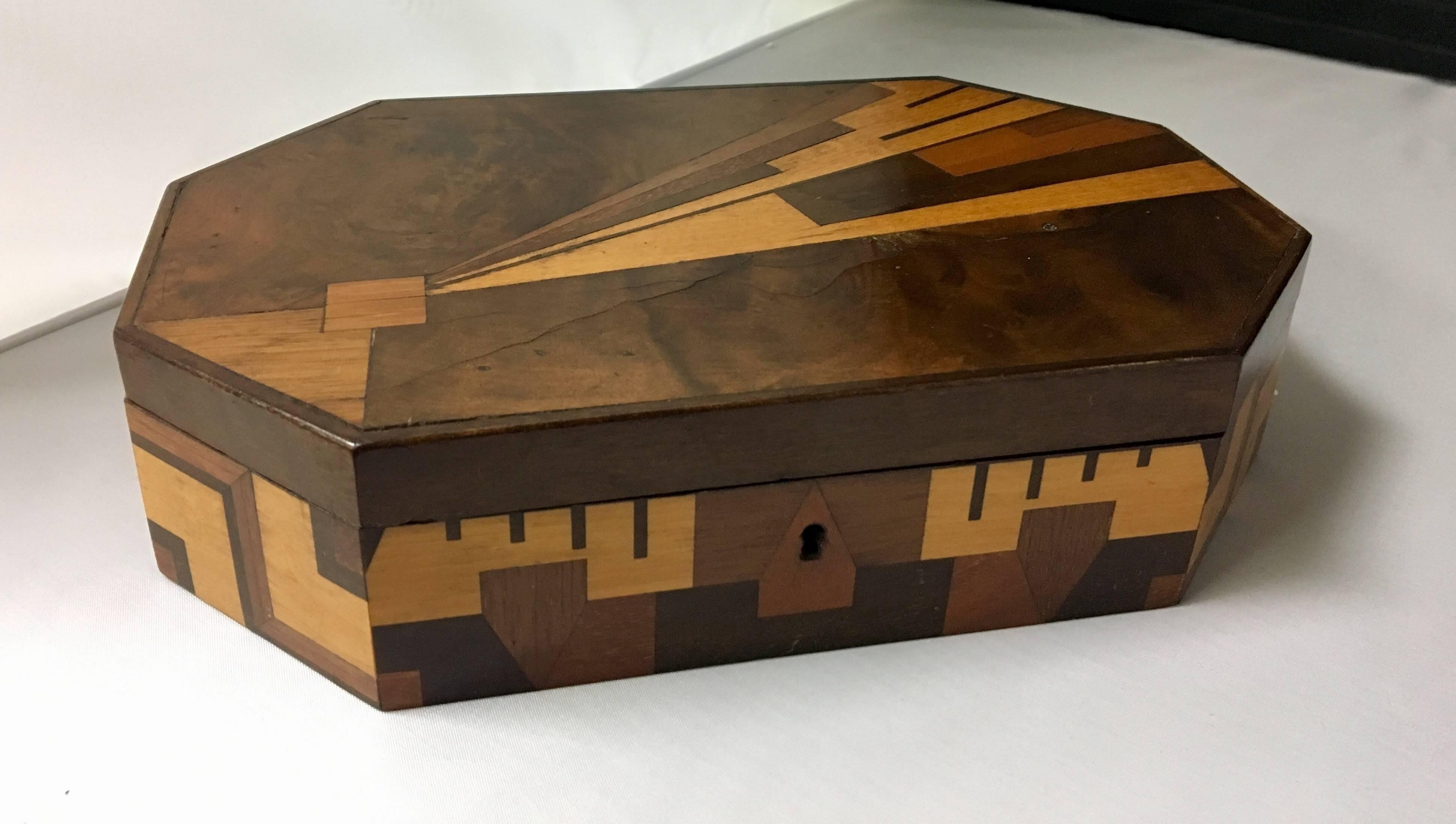 Very unique Brazilian inlaid marquetry box made of a number of hardwoods. Wonderful handmade piece with a great symmetrical design.