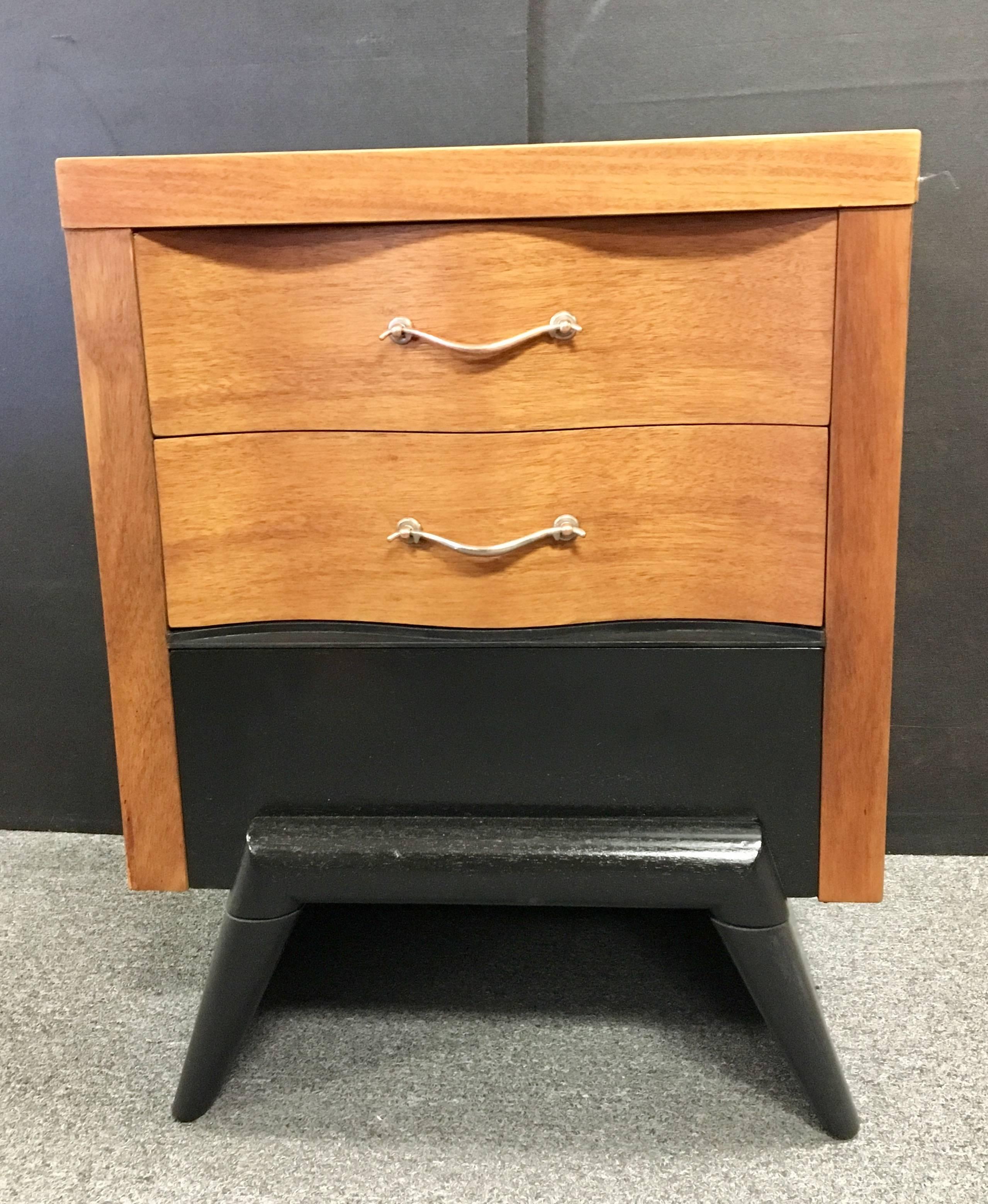 Elegant and unique pair of mahogany nightstands, circa 1950s. Great lines and freshly refinished with hand rubbed oil, black lacquer base and polished rose brass handles. Amazing quality and truly a striking pair!