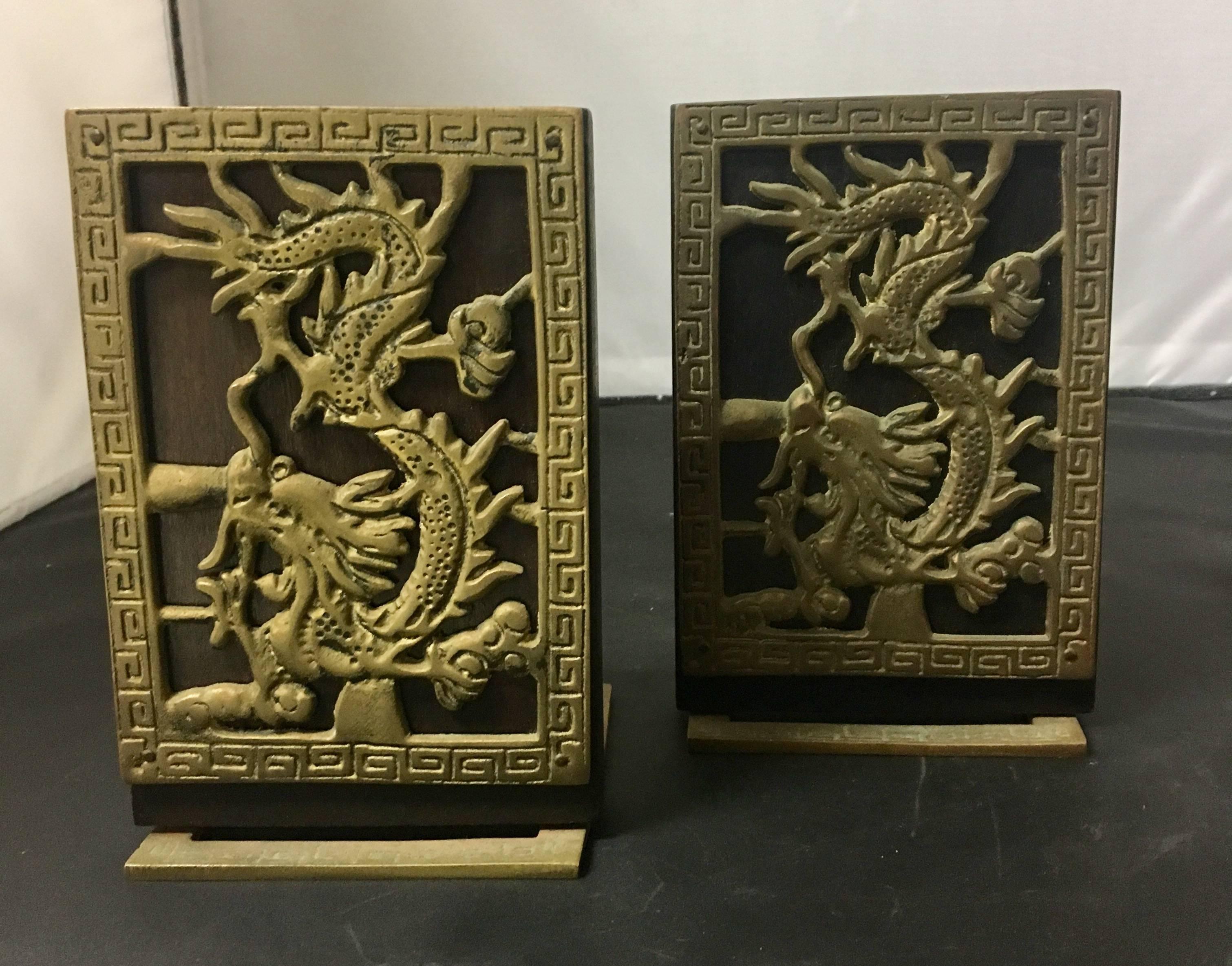 A nice pair of vintage bookends made of wood and brass with a Chinese dragon design.