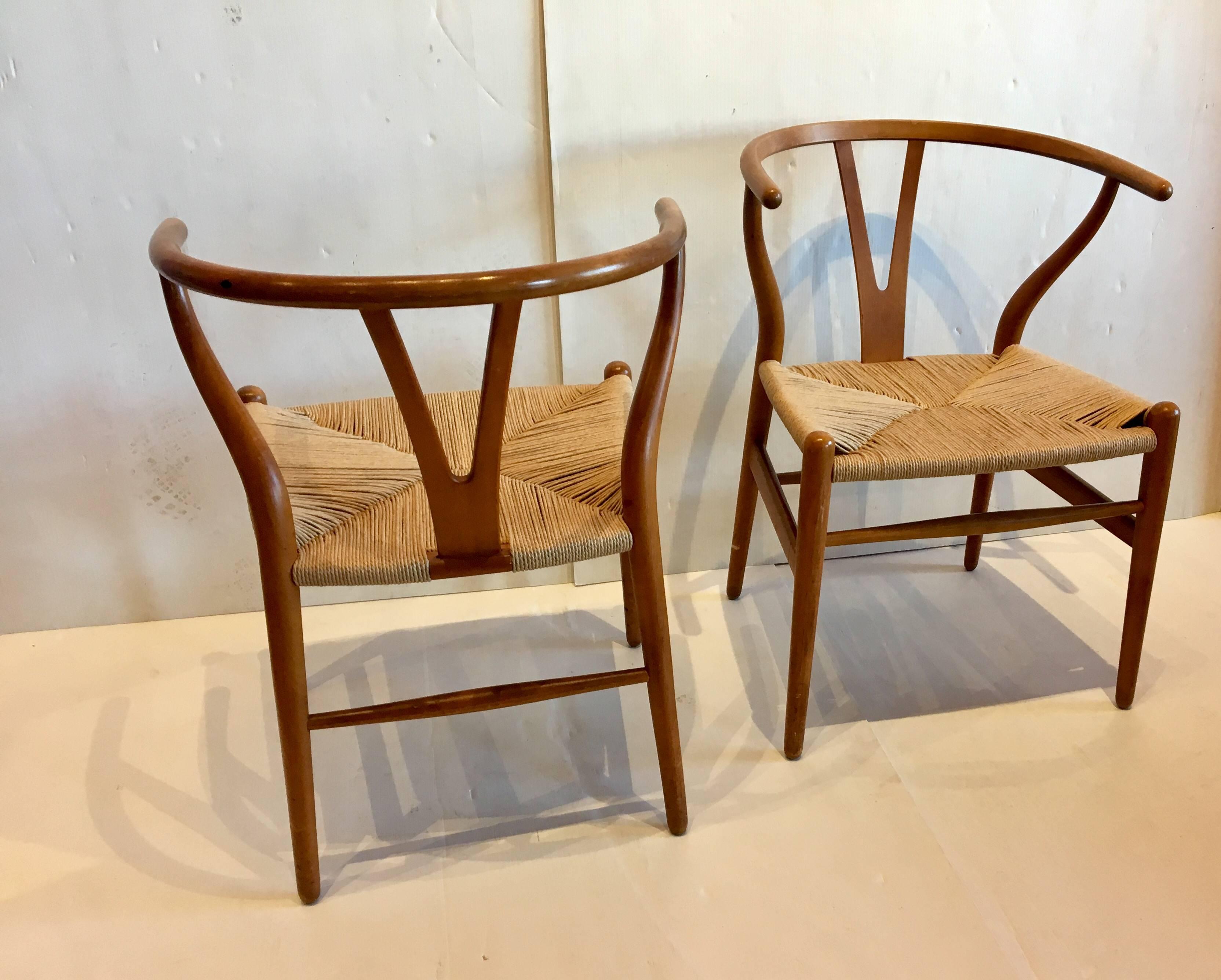 Nice pair of Wishbone chairs design by Hans Wegner, with original rope seats, great condition in birchwood finish with a walnut stain.