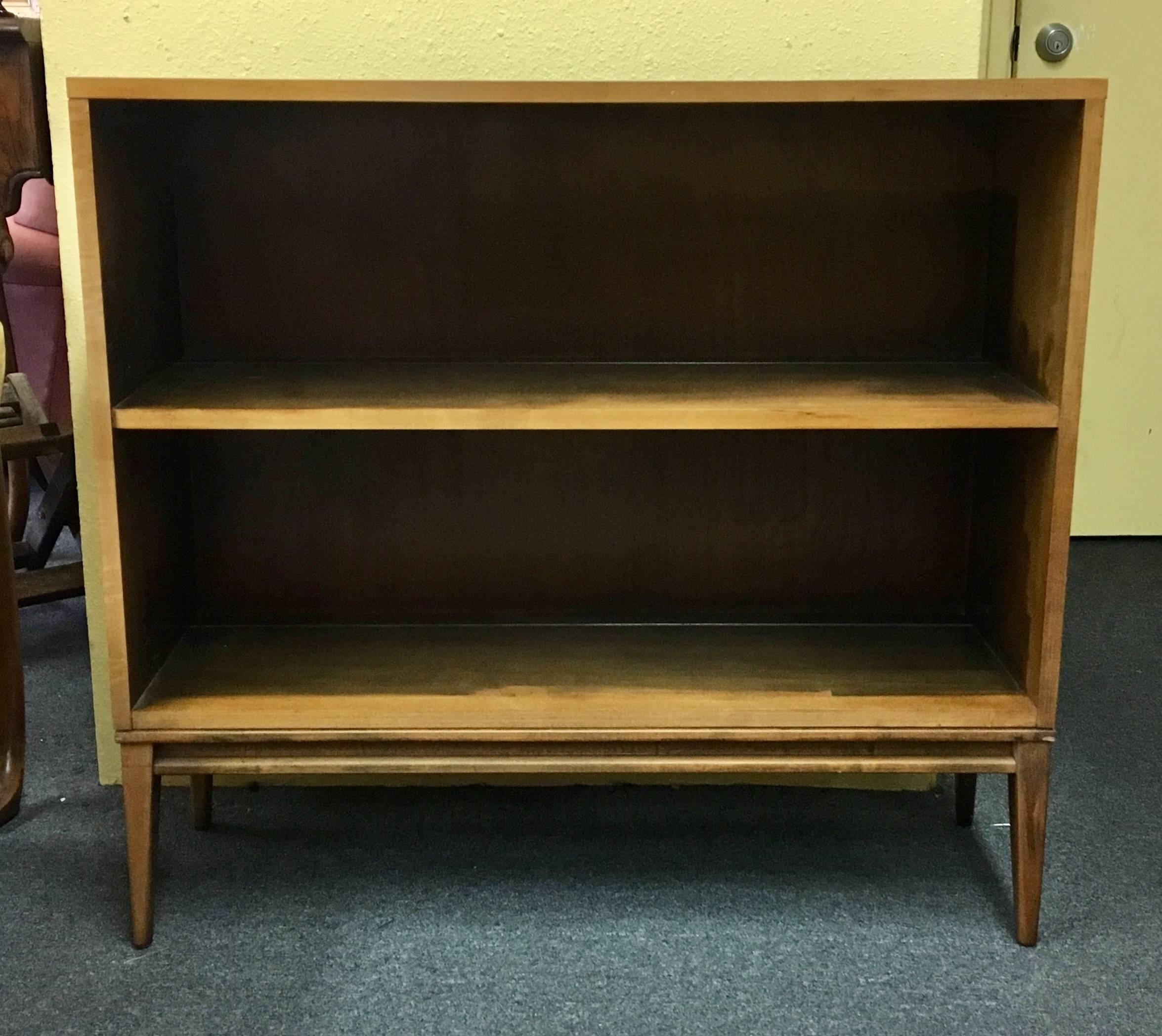Hard to find matching pair of solid birch bookcases designed by Paul McCobb as part of the planner group, circa 1950s. In original condition with walnut finish, aluminum foil label, and adjustable feet. Overall, very good vintage condition.