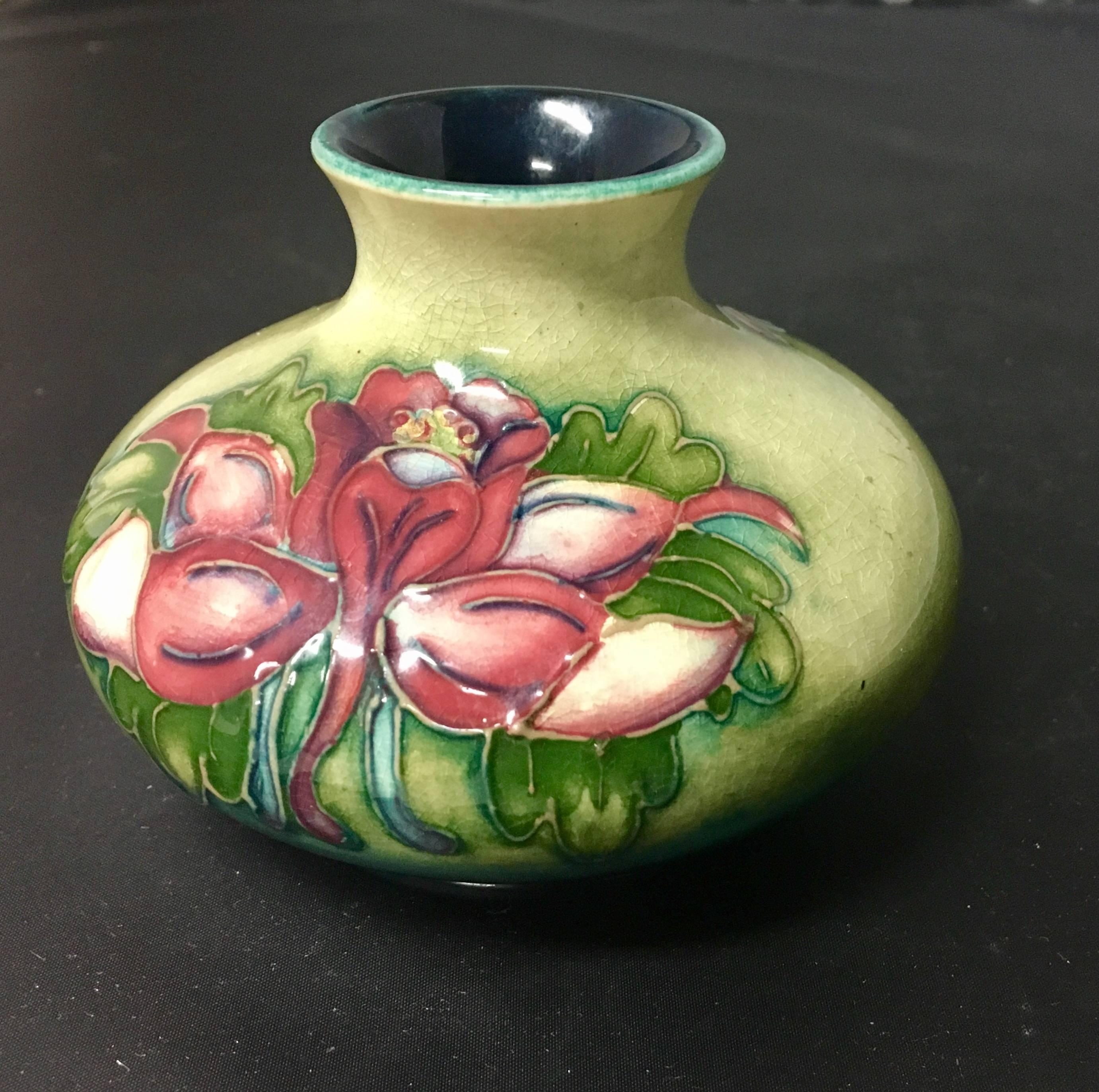 Rare English low art pottery vase by William Moorcraft, circa 1930s. The piece is signed and also has the designation "WM, Potter to HM the Queen". Excellent condition and vibrant floral colors.
