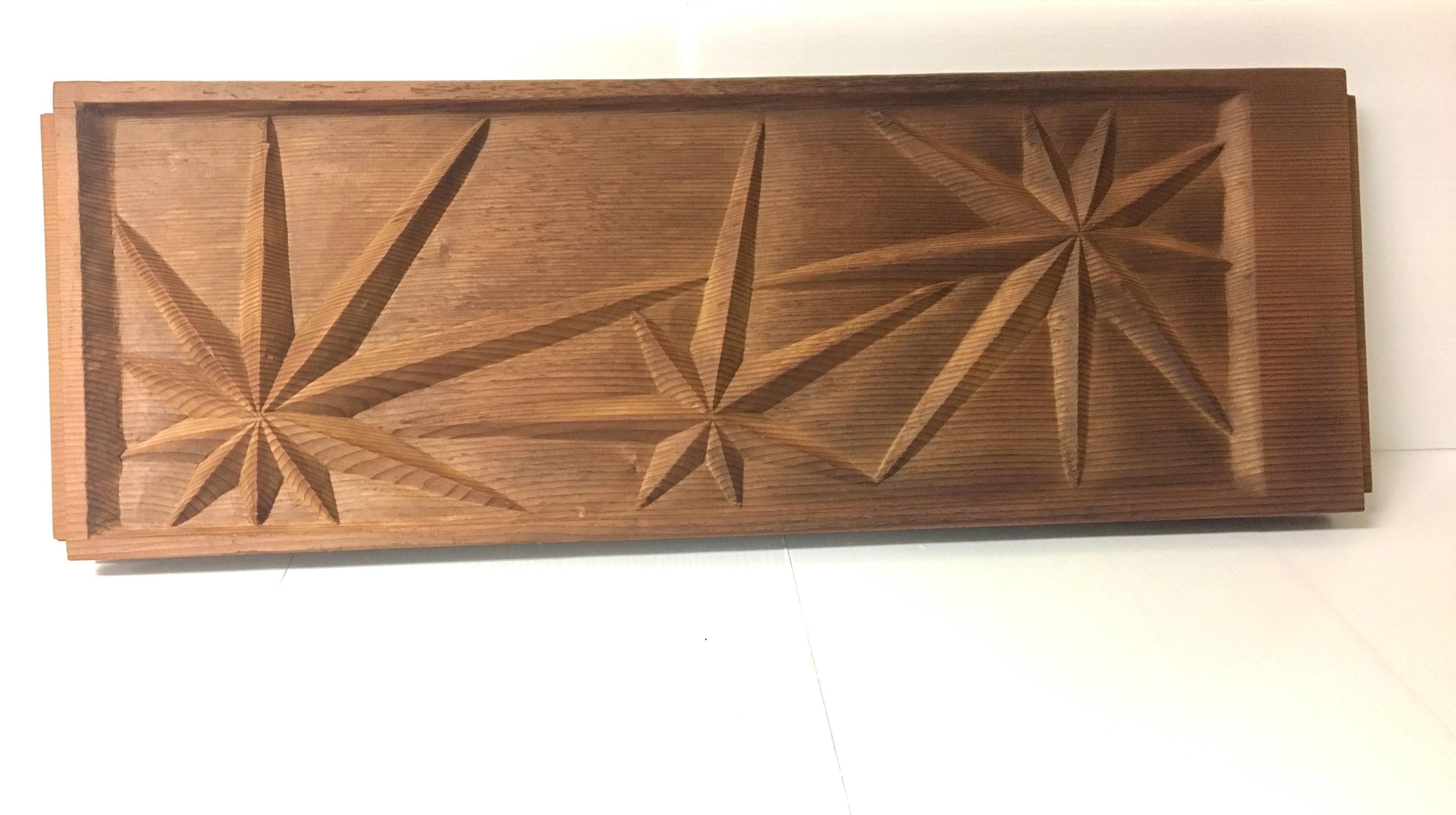 A very unique hand-carved wood panel of three sunbursts by artist Sherrill Broudy from the 1950s. The panel measures 11.25" x 33" and is in very good vintage condition.