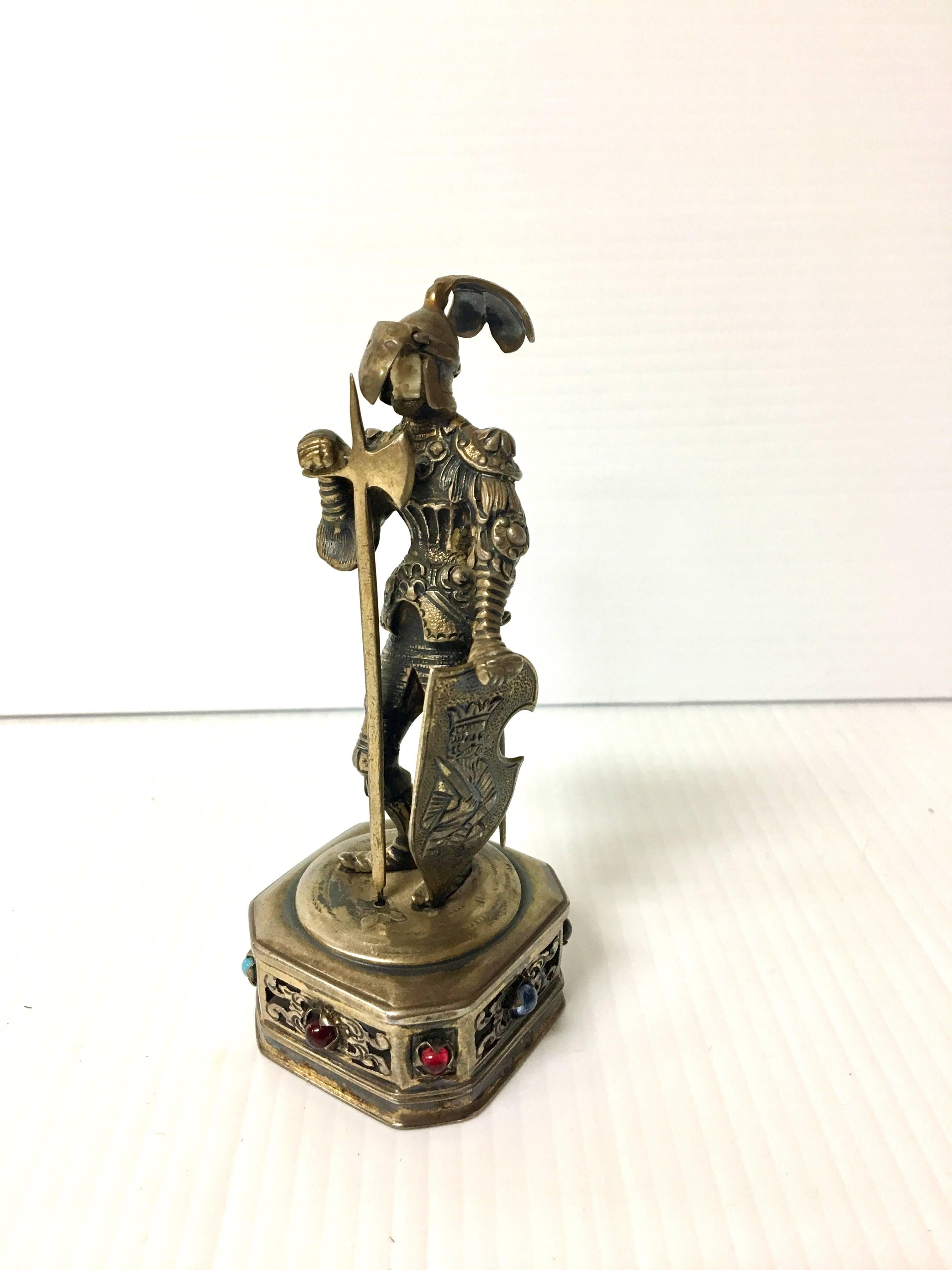 Rare and unique small jewel encrusted sterling silver knight statue with movable face guard. The face of the statue appears to be bone. The piece is 4.5" tall and stamped "925 Sterling Germany". Nice patination and detail.
