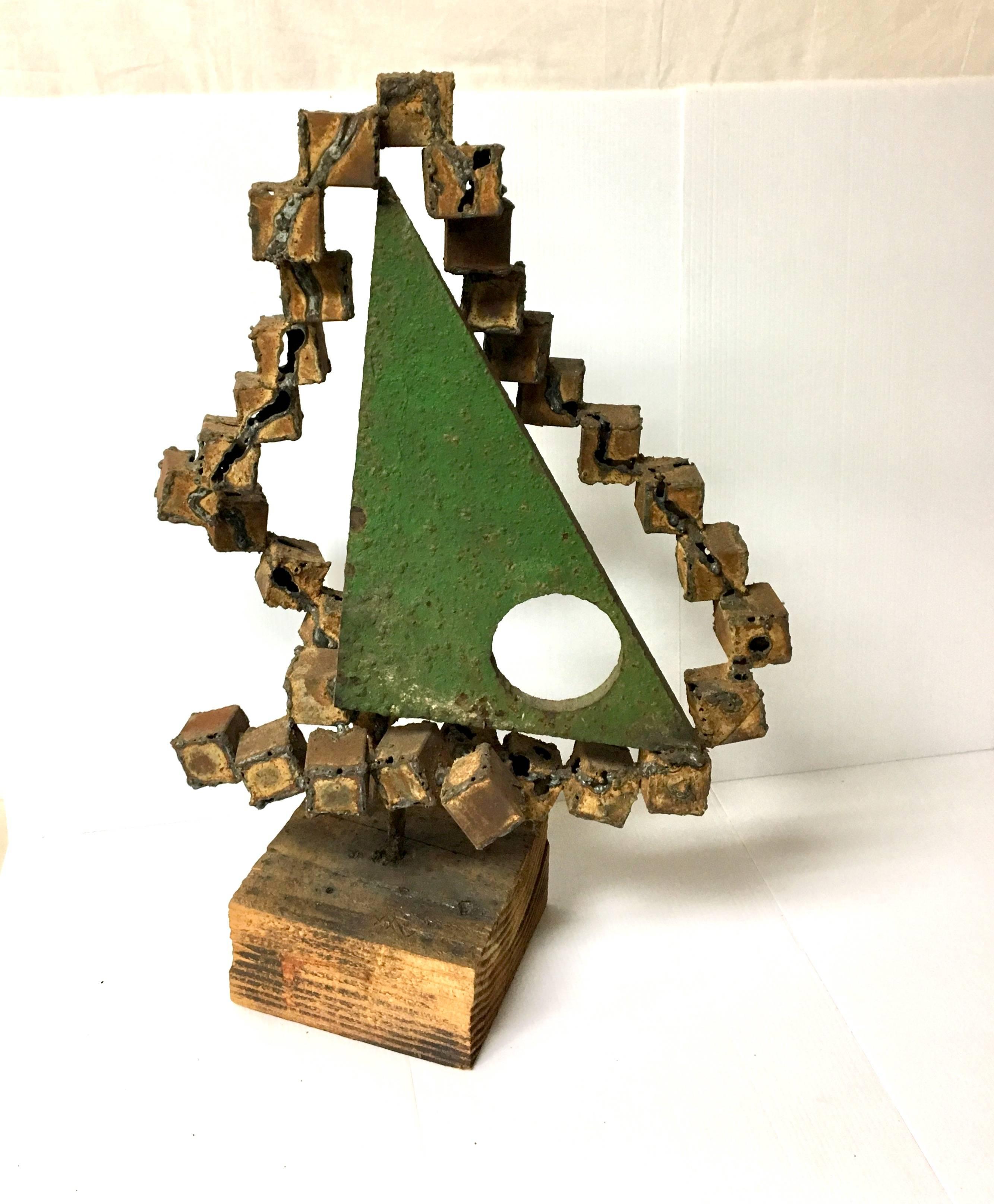 Very unique raw Brutalist metal sculpture on wood base by American metal sculptor Frank Cota. The piece issigned on the base. Nice green patina on the triangle.