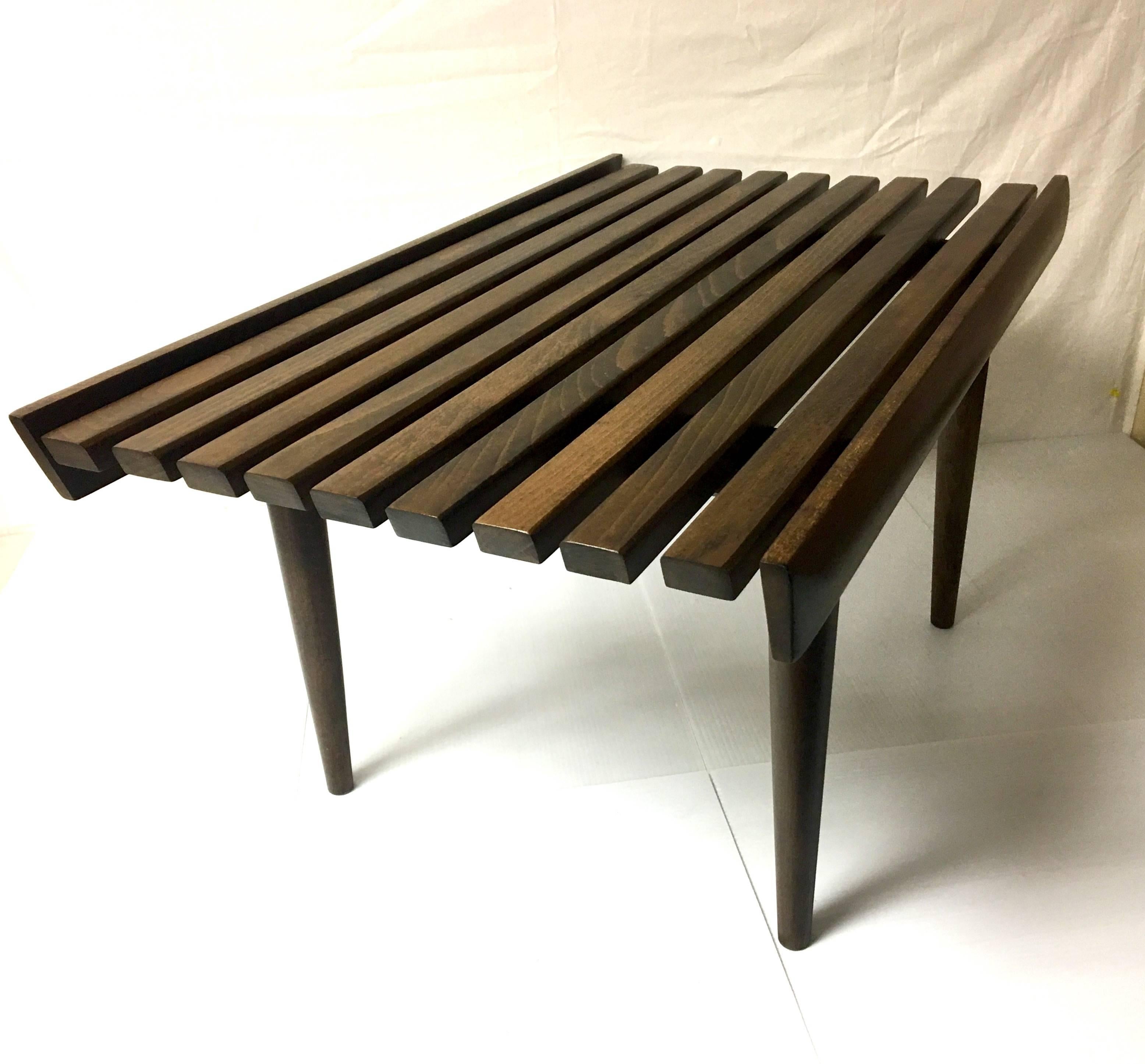 Elegant Japanese style small slat bench, circa 1950s, freshly refinished in walnut. The piece is solid and sturdy with tapered legs that can be removed for easy storage or shipping. Nice angle edge end cut; can be used for seating or as small coffee