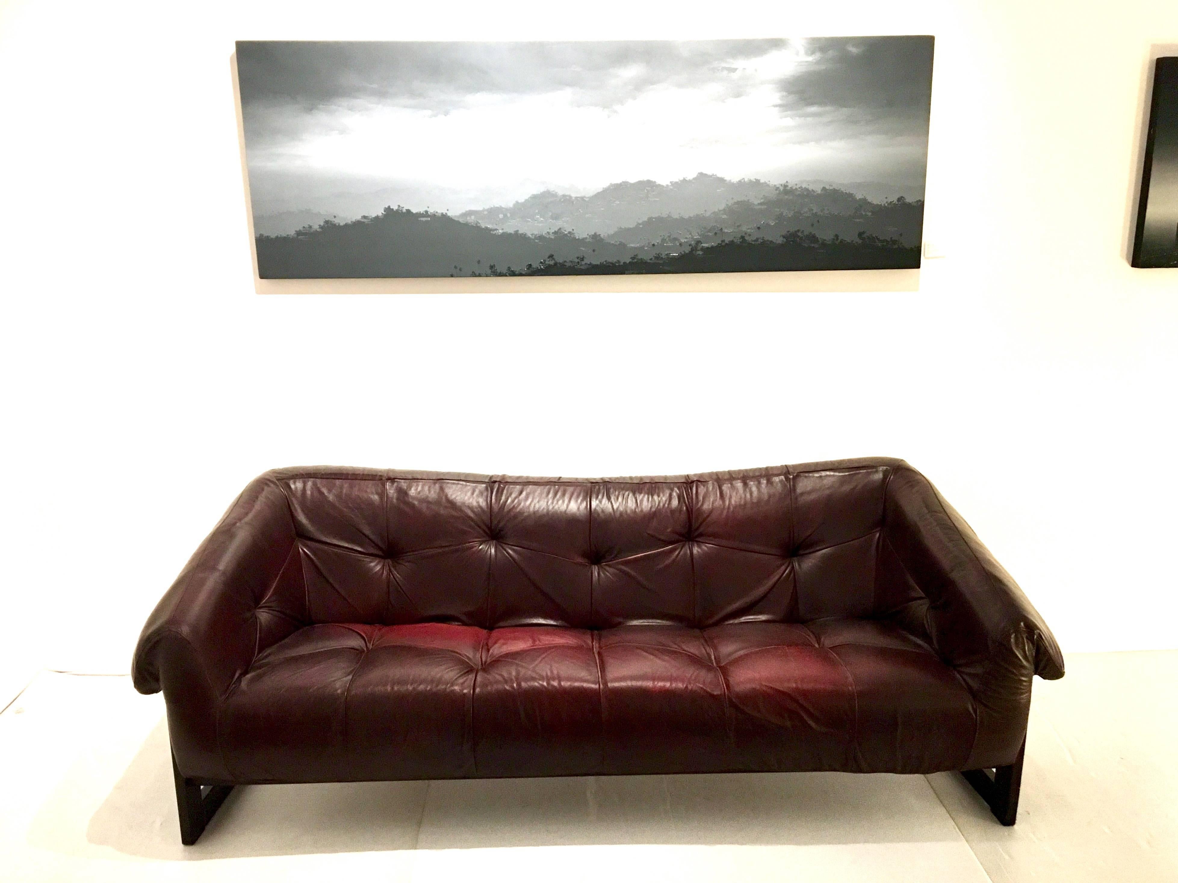 Beautiful burgundy leather sofa by Percival Lafer, nice rosewood frame solid all in its original condition. Made in Brazil nicely worn leather the leather its worn and a little discolored as shown on the pics.