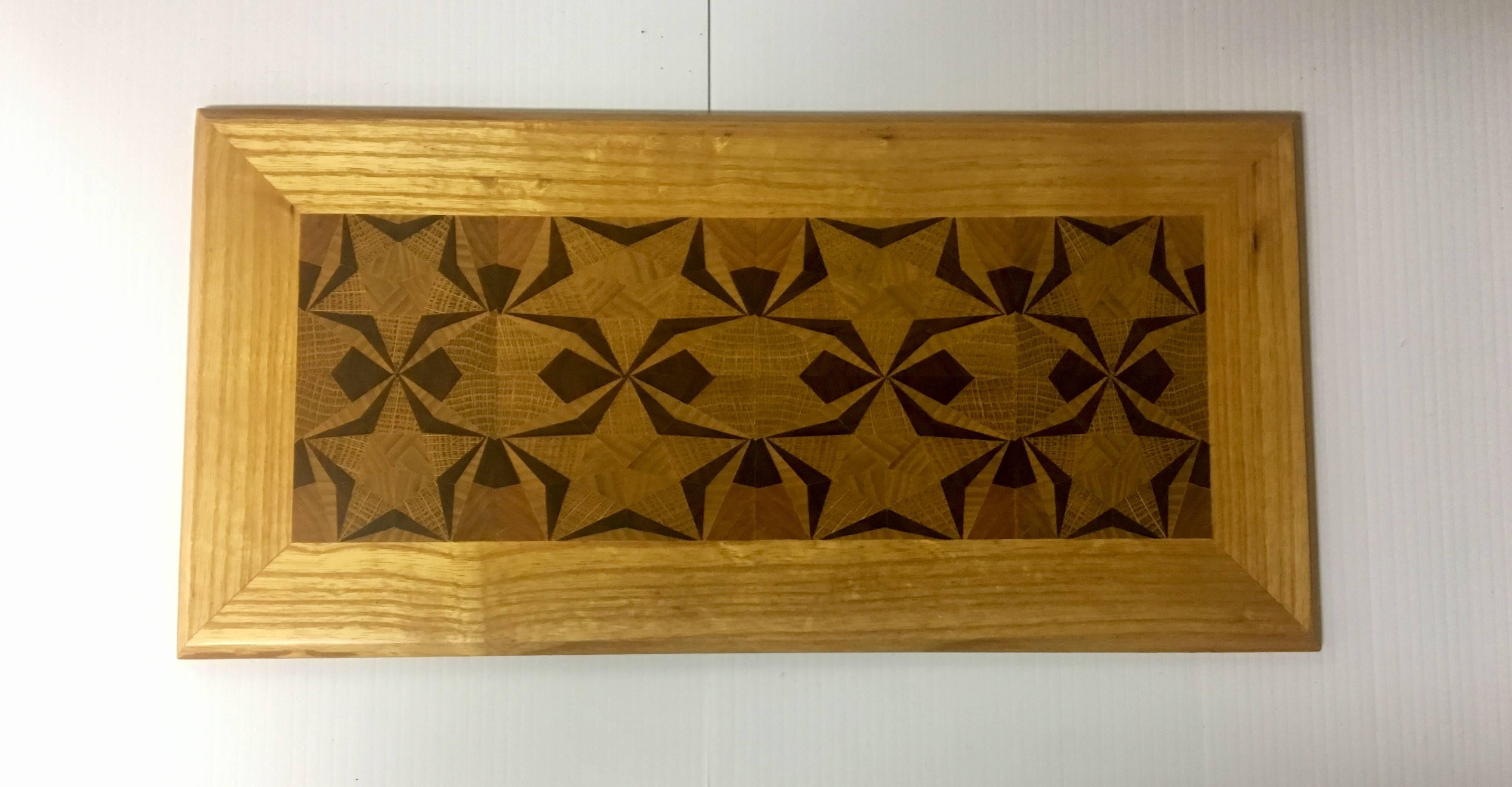 Incredible handcrafted wood work on this small wall plaque, circa 1970s. The piece is in excellent condition and has a nice geometric design.