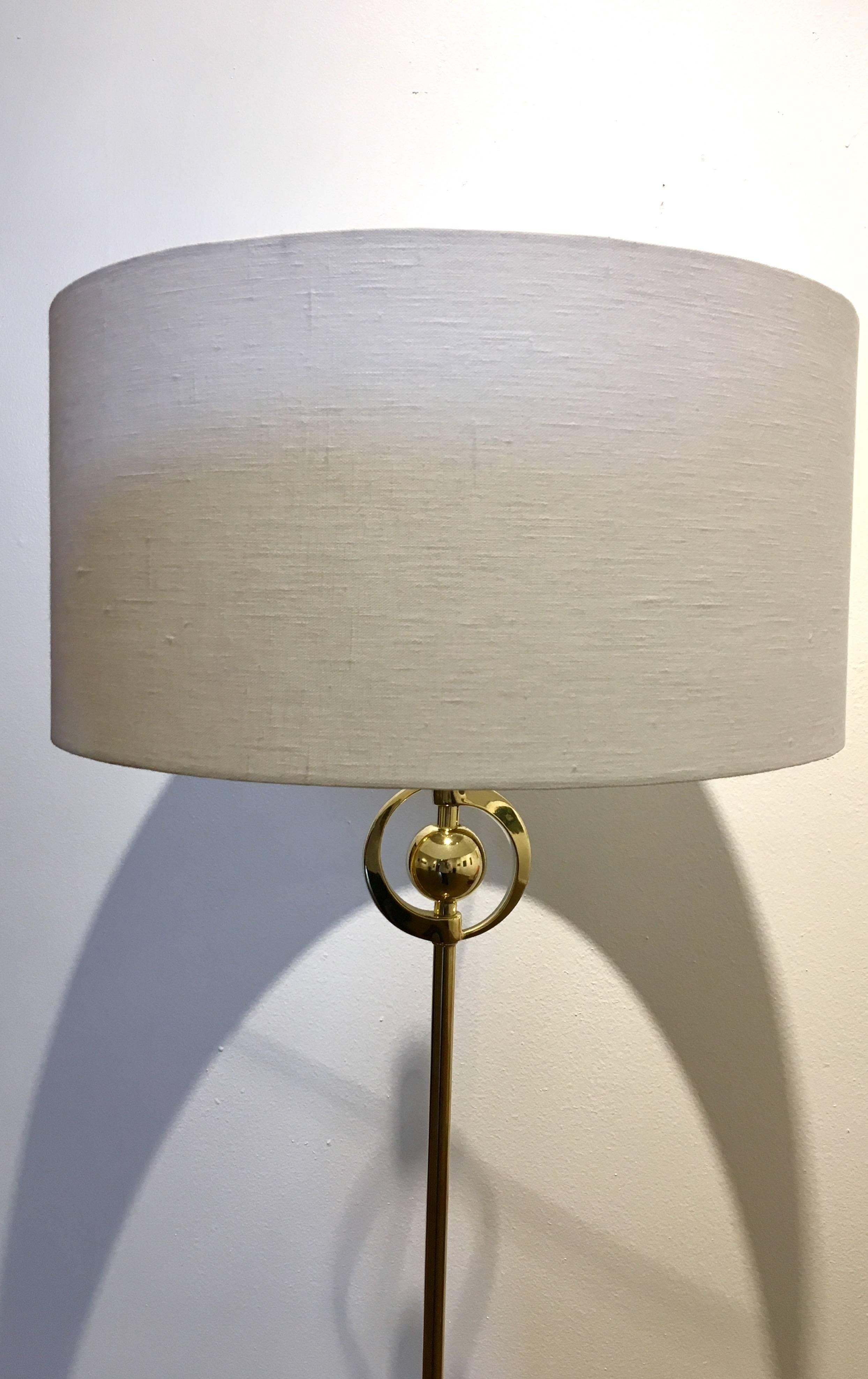 Beautiful and rare floor lamp, circa 1940s, polished brass rewired and new lampshade with new socket, we had to replace the old socket, great design. We put an Lucite finial.