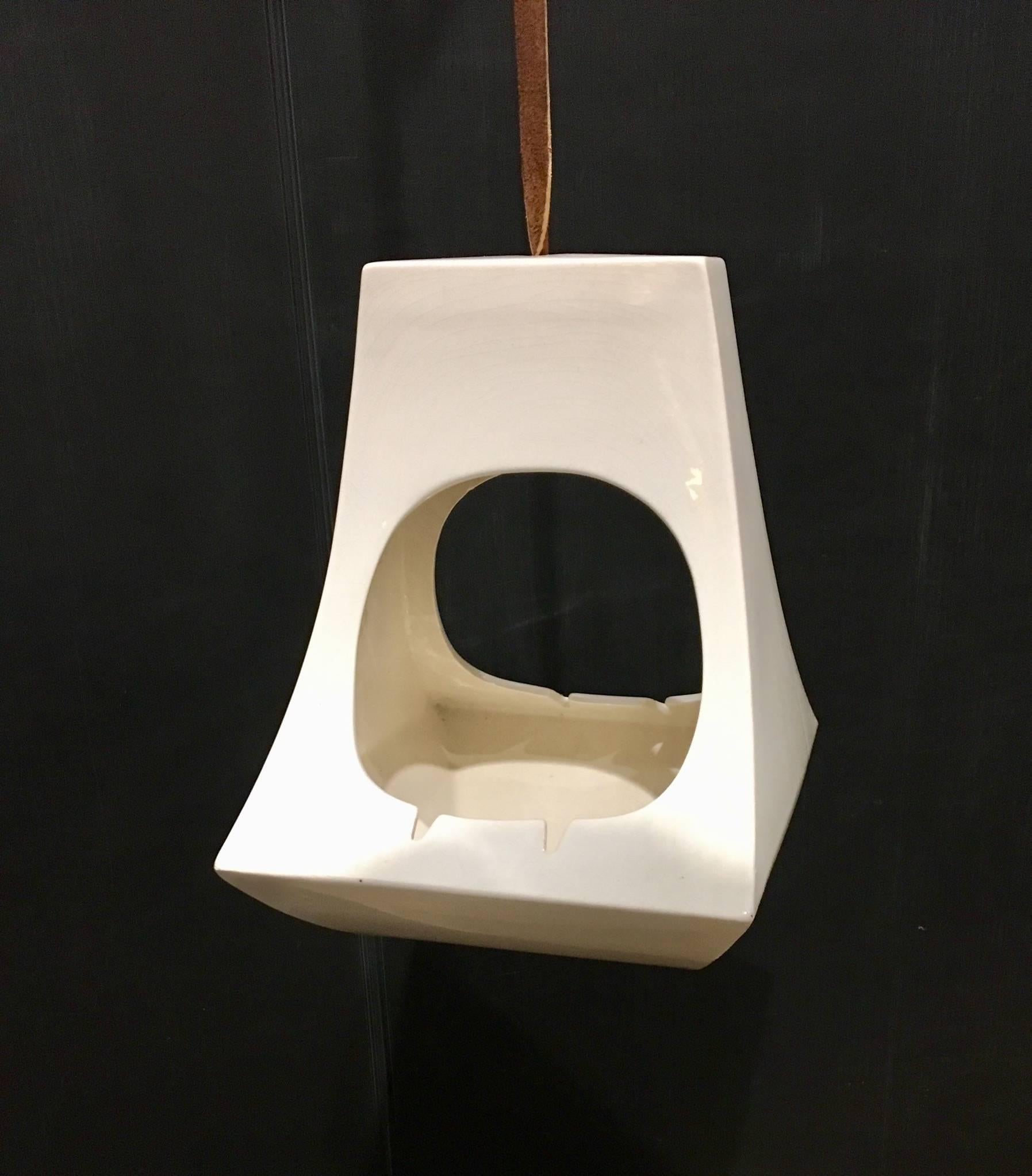 Cool 1960s ceramic hanging ashtray, bird feeder or planter in cream color with leather strap, nice condition and great shape.