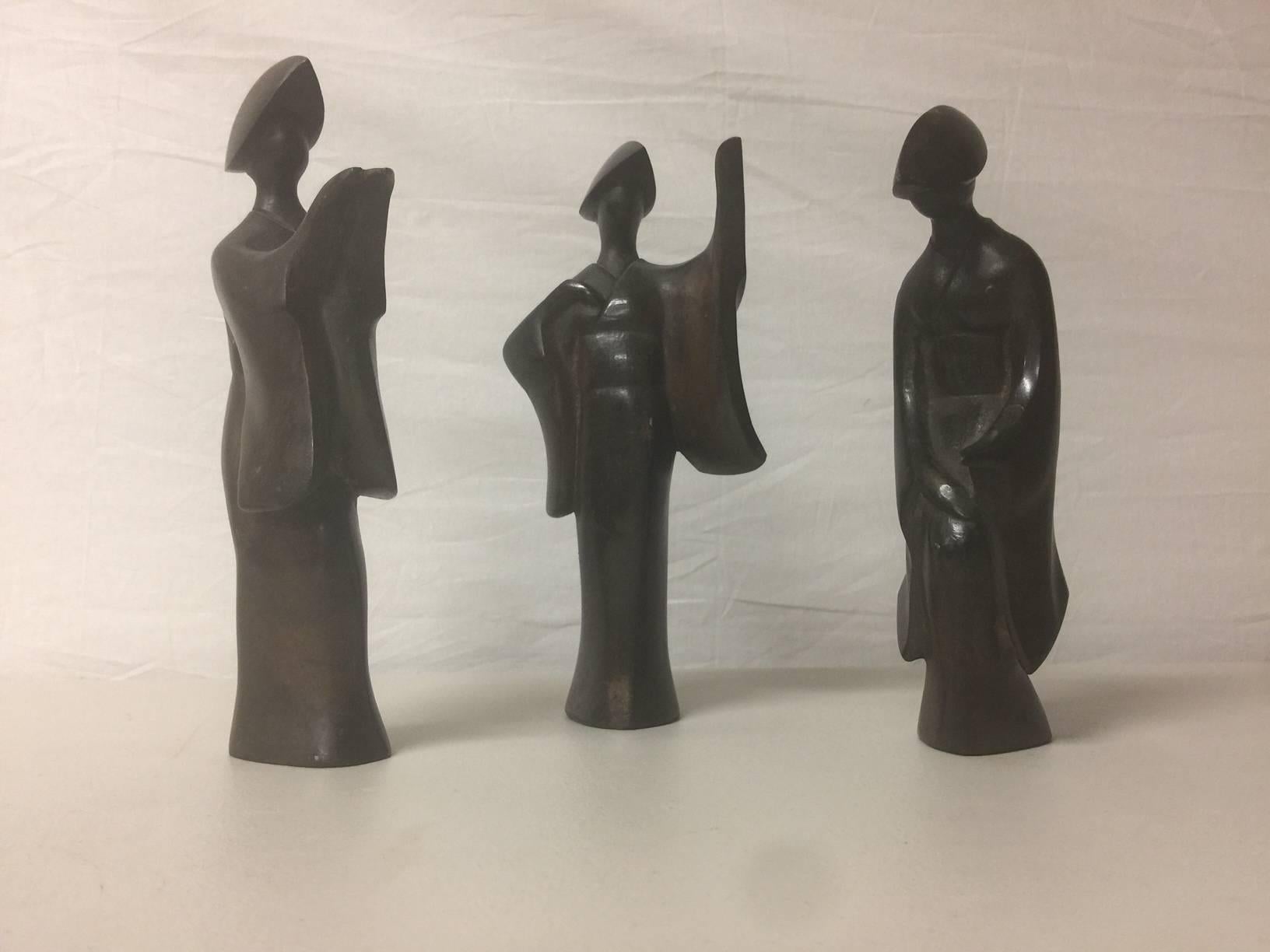 A very cool set of three large (9" tall) bronze Japanese geisha figurines, circa 1960s. The pieces are very heavy and solid and have a real nice dark patina; they would make a great Mid-Century Modern accent in any space!
