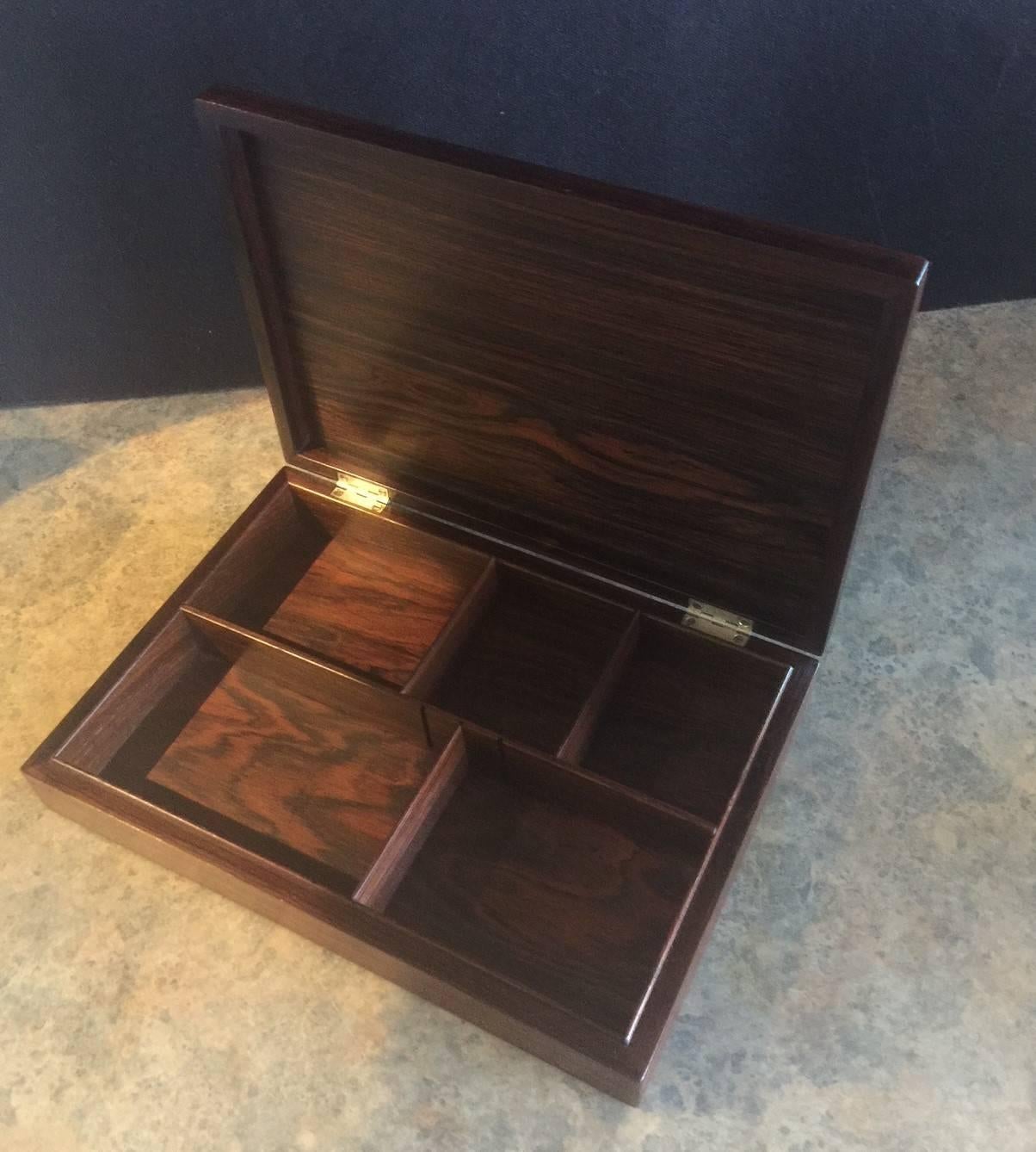 Gorgeous midcentury rosewood storage box by Wiggers of Denmark, circa 1960s. The box is massive; 12" wide by 8.25" deep and has a fixed center divider and 3 removable dividers to set up multiple configurations. Wonderfully handcrafted with