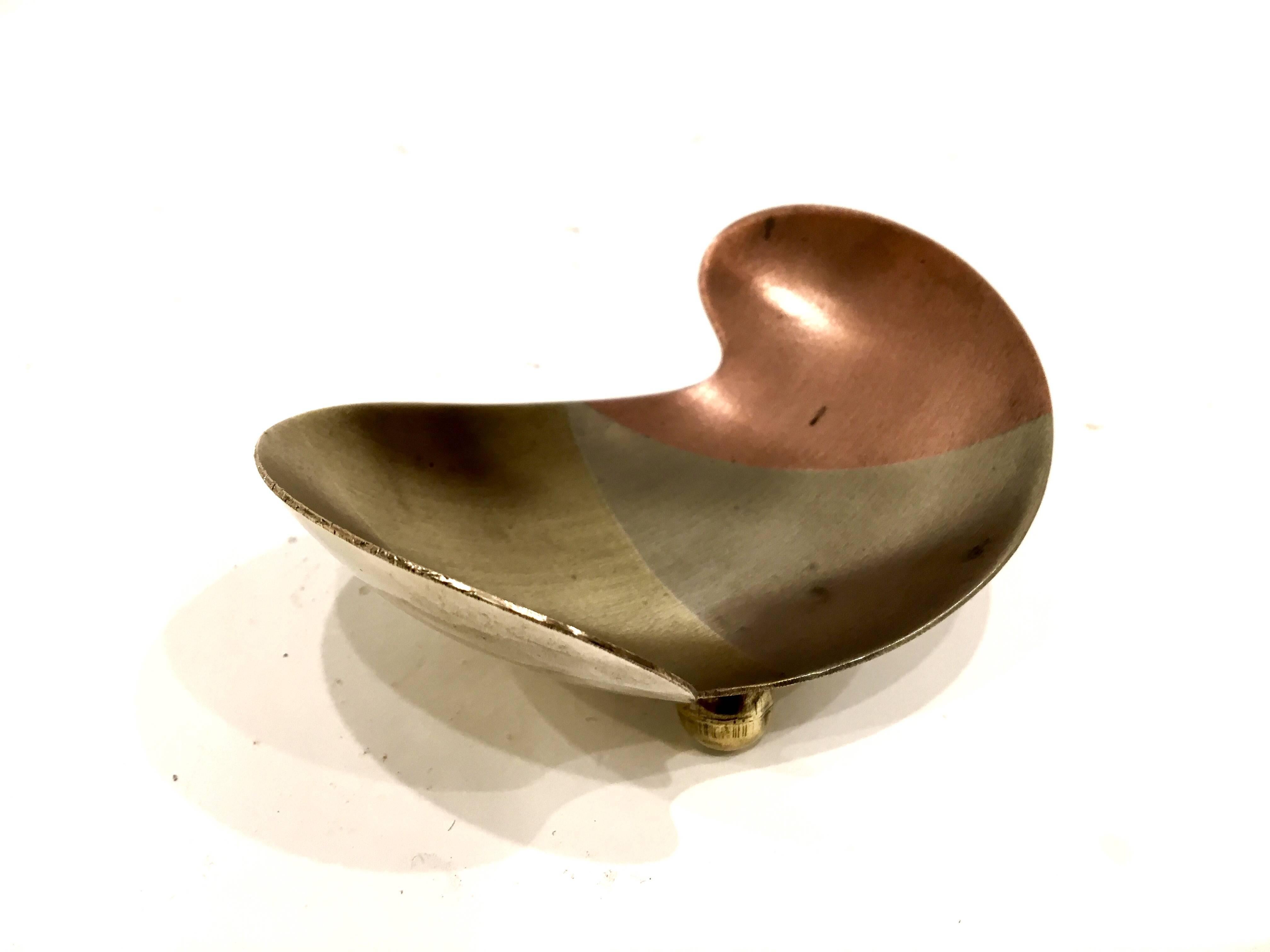 Beautiful free-form shape small bowl, hand-hammered in copper, bronze, brass and silver, circa 1950s sitting in three ball little feet, iconic shape from the 1950s era.