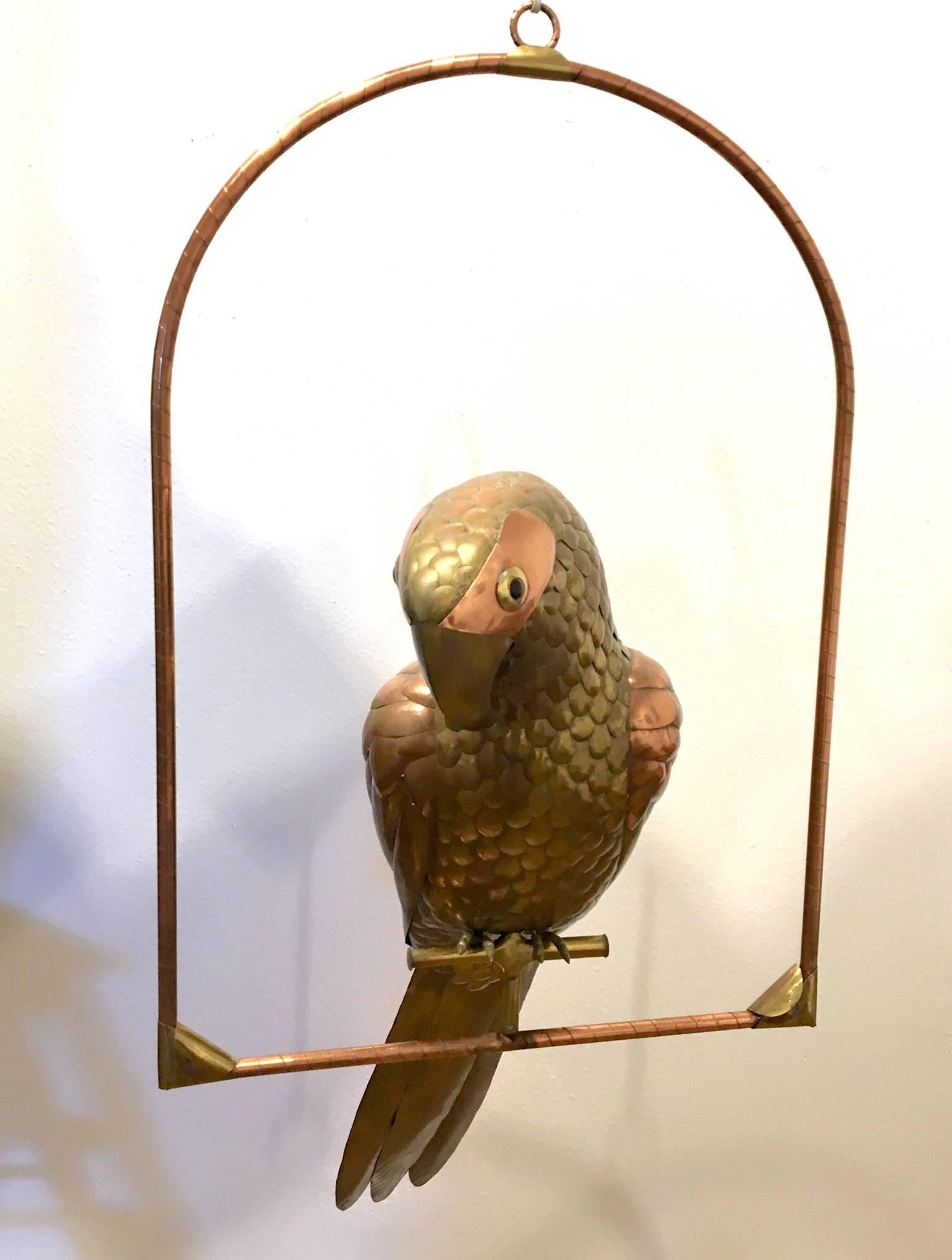 Striking extra large mix metal parrot by Sergio Bustamante hanging perched parrot. Sculpture its in excellent condition. With beautiful patina. The parrot its self its 38* long.