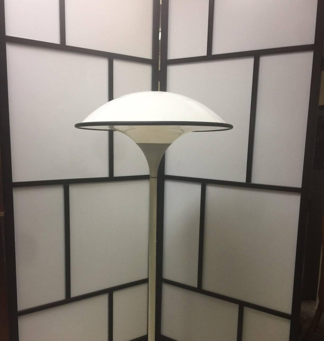 A modernist floor lamp by one of Denmark’s most highly regarded lighting manufacturers, Fog & Mørup, Denmark. The designer is Dansk, produced 1960-1975. A white perspex hood with black rubber edging sits on top of a metal stem giving a warm diffused