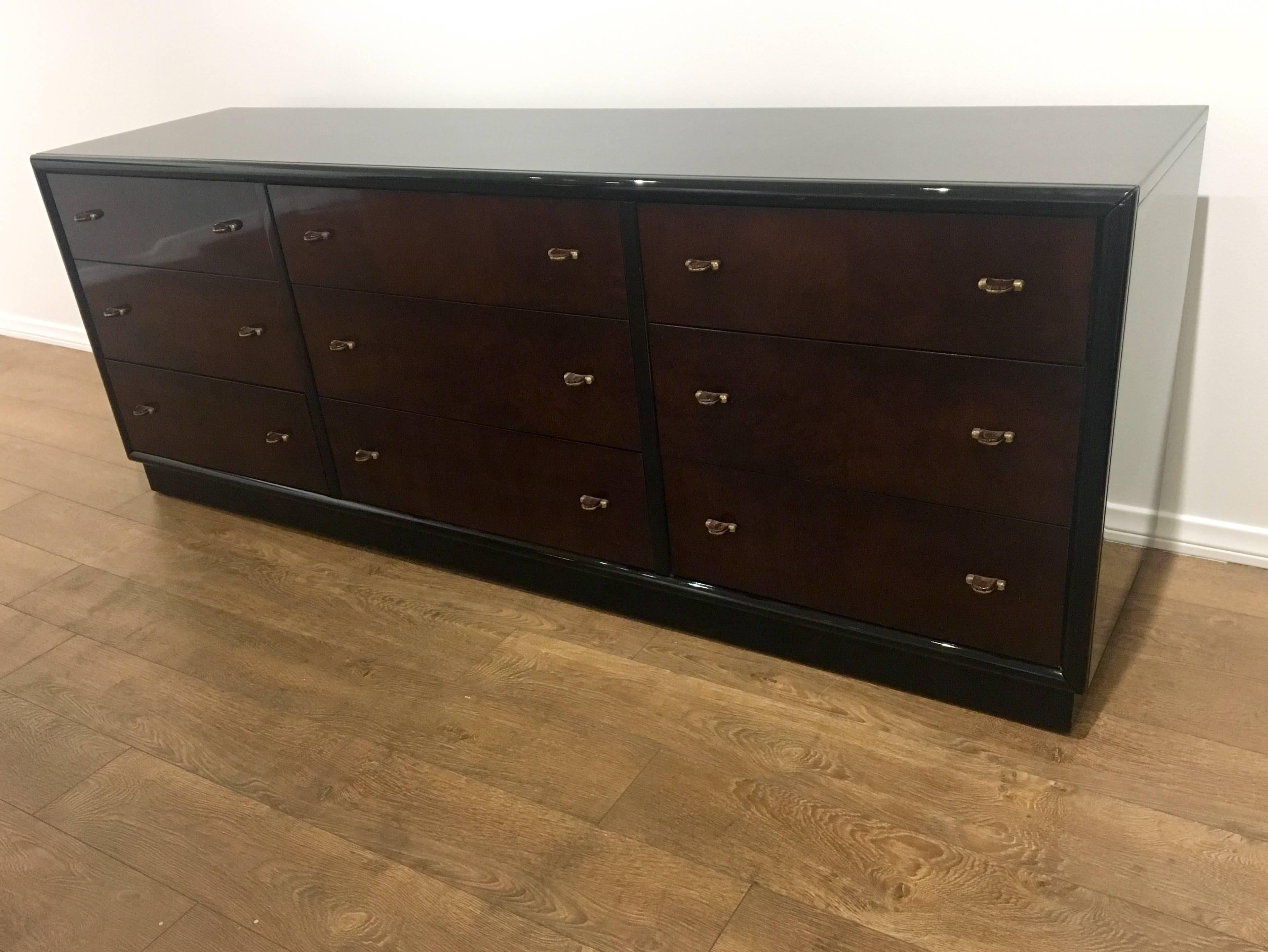 Long nine-drawer long dresser by Henredon from their "Scene Three" collection Smooth black lacquer frames vibrant Myrtle burl veneer drawer fronts, circa 1980s very clean and nice condition exceptional quality with drawer-pulls are