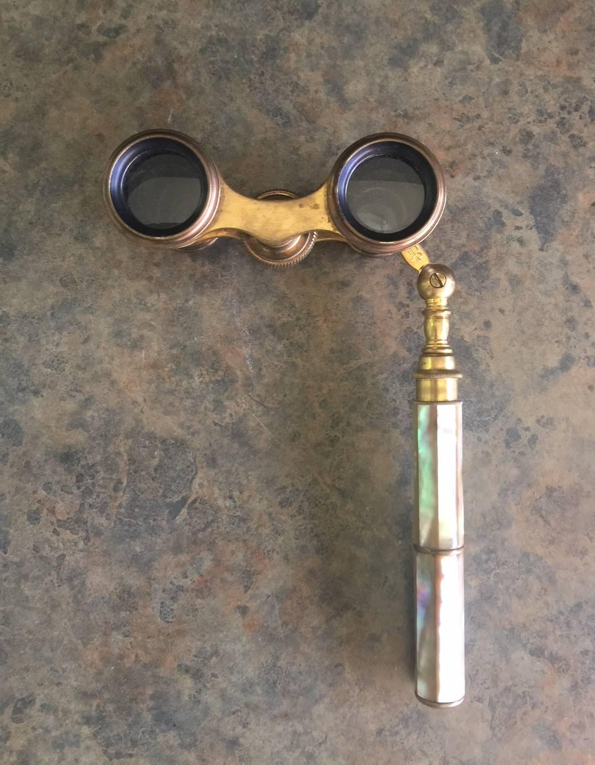 Fabulous vintage mother-of-pearl and brass opera glasses made by Chevalier in Paris. 

Complete functional glasses, the lenses may need some cleaning but this does not affect the clear view; focus bar works great. This stunning pair would look
