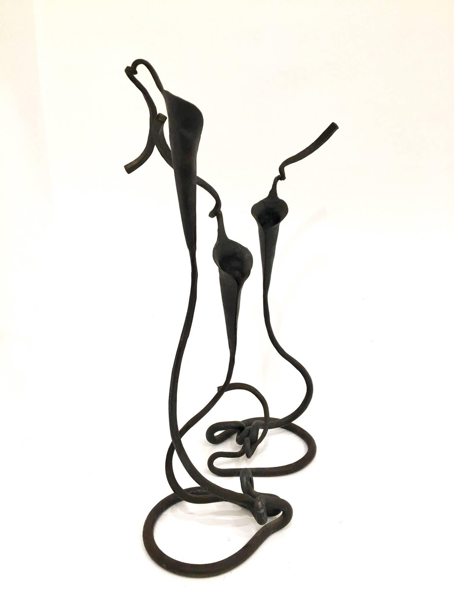Stylish pair of hand-wrought iron Lily candlesticks by artist, designer and blacksmith Jack Brubaker.