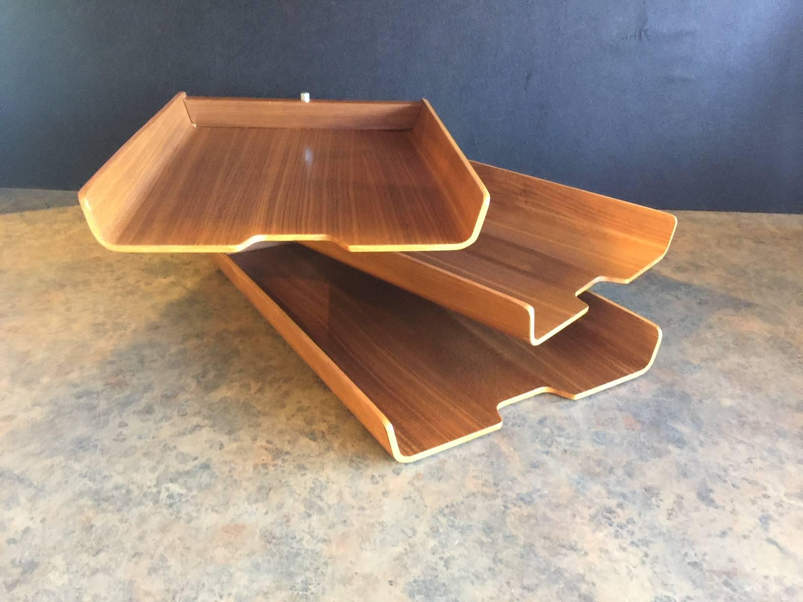 Very cool and functional triple letter tray by Martin Aberg for Rainbow Wood Products Company of Sweden, circa 1960s. The trays are made of molded teak plywood and can swivel into any number of configurations to meet your office needs. The set is in