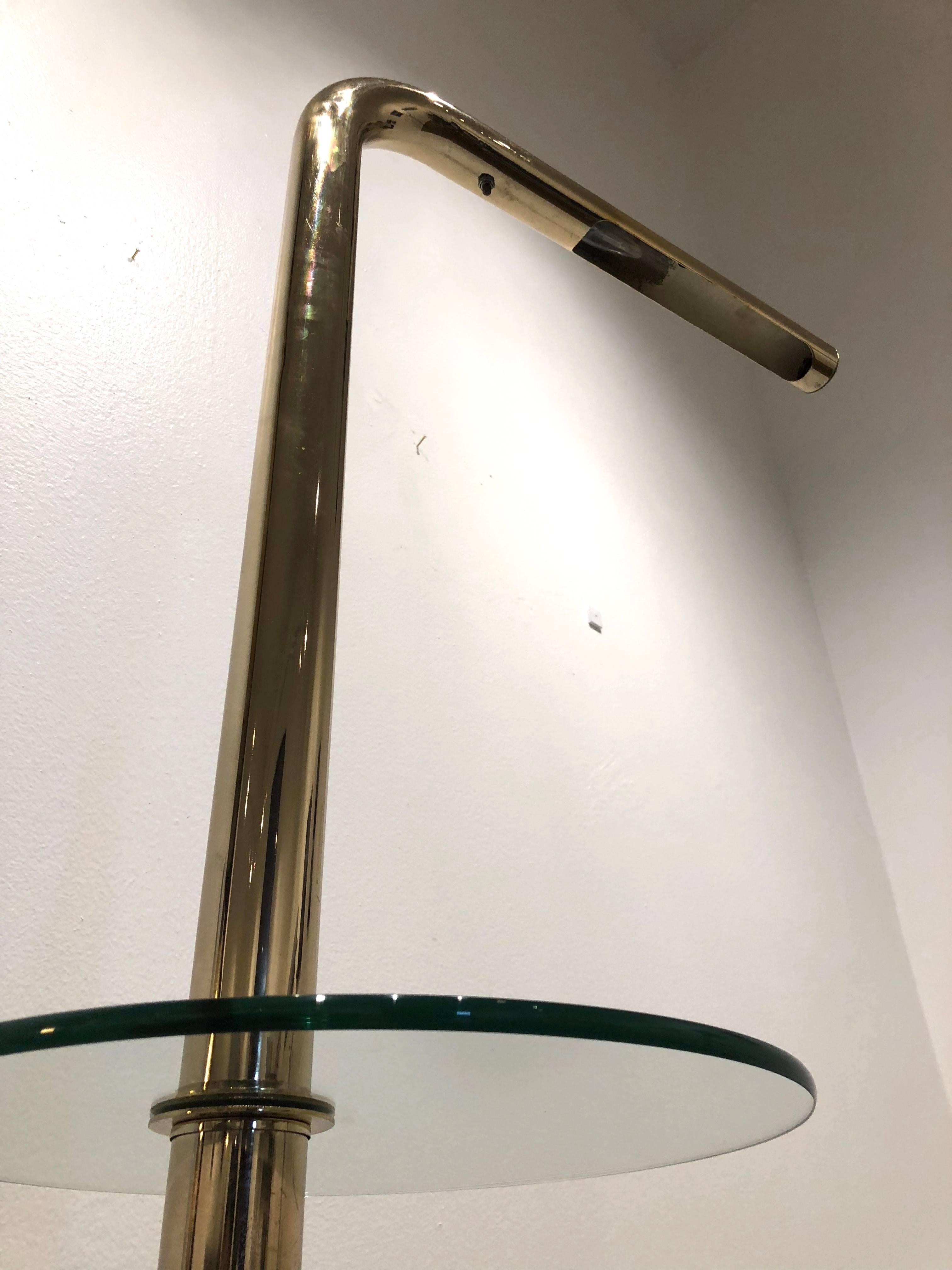 Fantastic 1970s floor lamp in a polished brass finished with glass table attached made by Robert Sonneman.