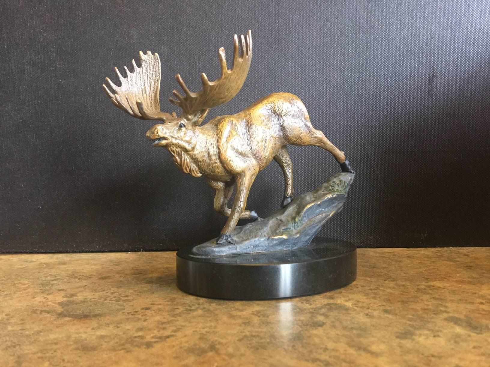 Very nice and detailed hand painted bronze moose sculpture on a black marble oval base. Th piece measures 6