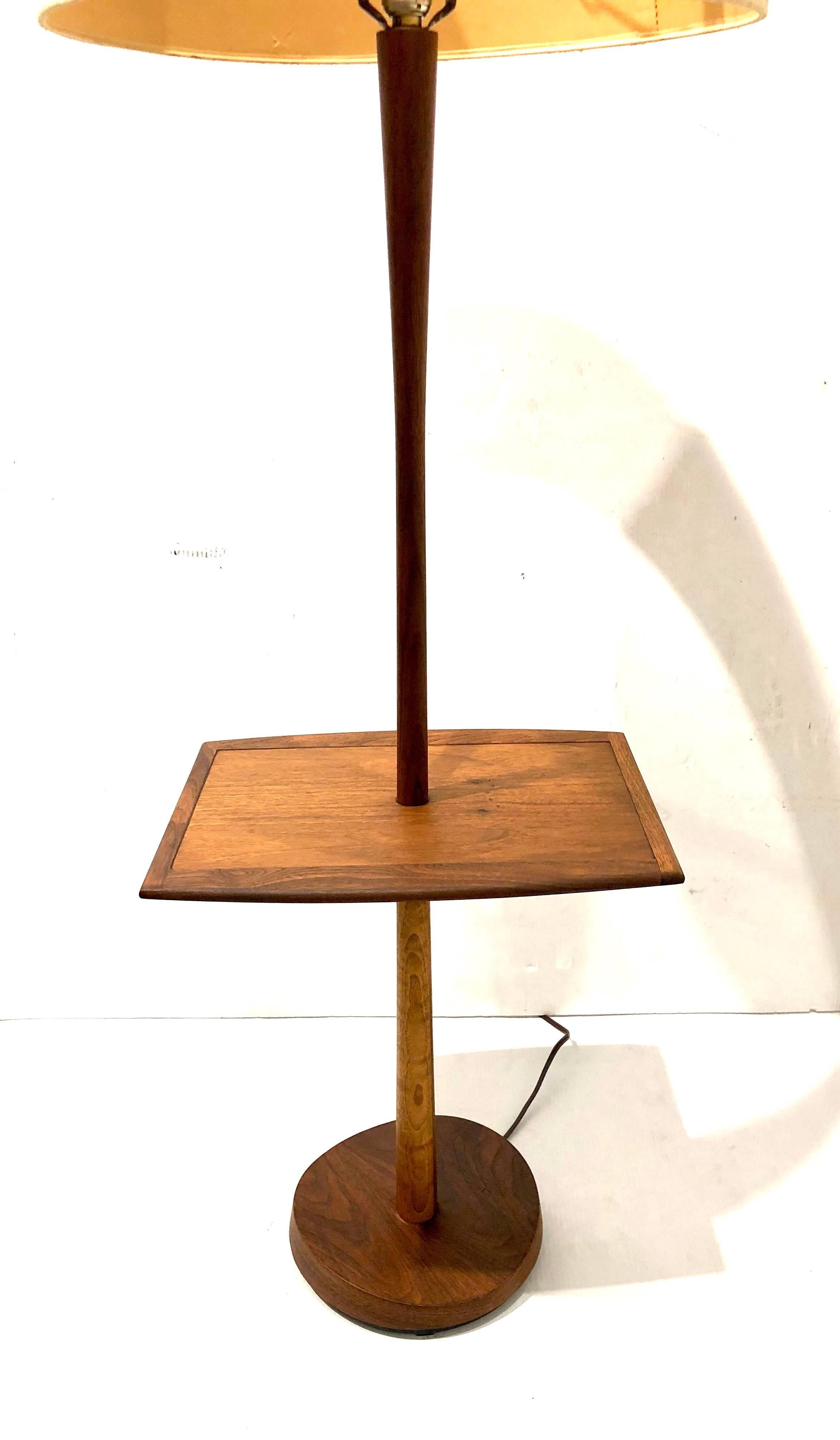 Beautiful solid walnut table lamp, circa 1950s freshly refinished and restored and rewired, iconic piece with its original lampshade in very nice and clean condition 19' in diameter and 11" tall lampshade dimensions.