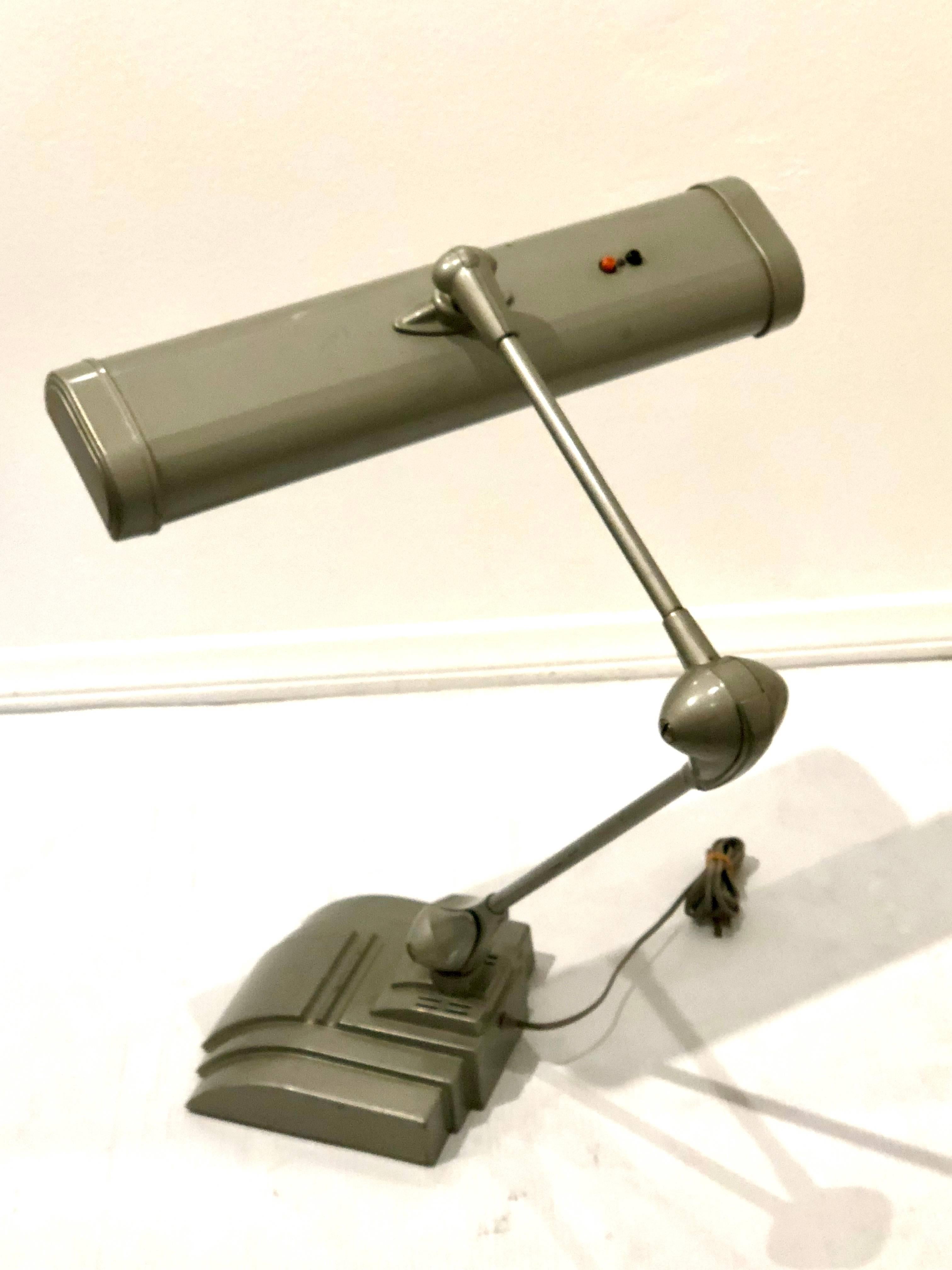 Massive Industrial multidirectional desk lamp by Flexo, in gunmetal gray original finish in great working condition and nice clean finish, double halogen lights and nice flexible arm.
