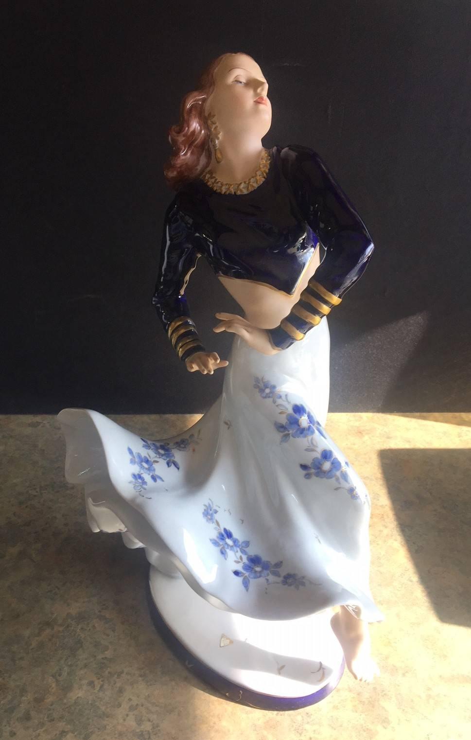 Large finely crafted porcelain figurine depicting 1940s Hollywood starlit, Rita Hayworth, dancing with a flowing dress and gold gilt highlights by Royal Dux, circa 1980s. This lovely piece is made of fine quality Czechoslovakian hand painted