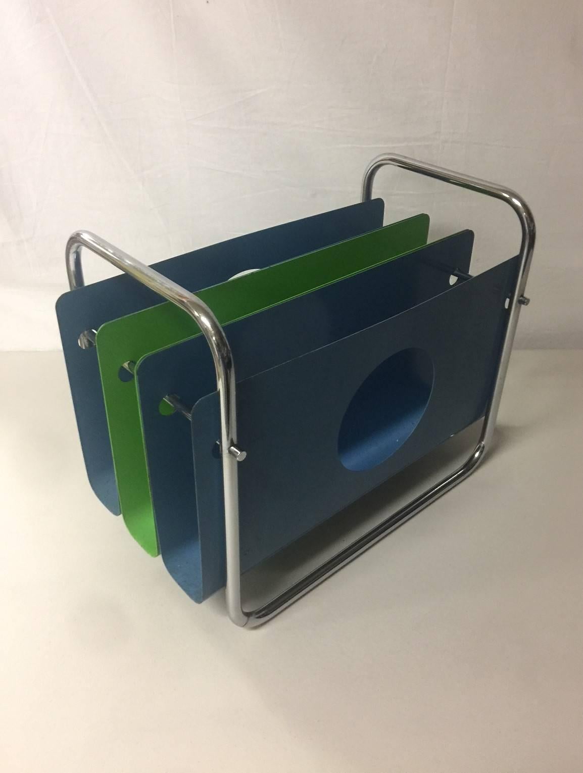 A rare and unique painted sheet metal and chrome magazine rack by Peter Pepper Products, circa 1970s. The piece is in good vintage condition with some fading, marks and chips (please see pictures). This is a very rare piece as I was not able to