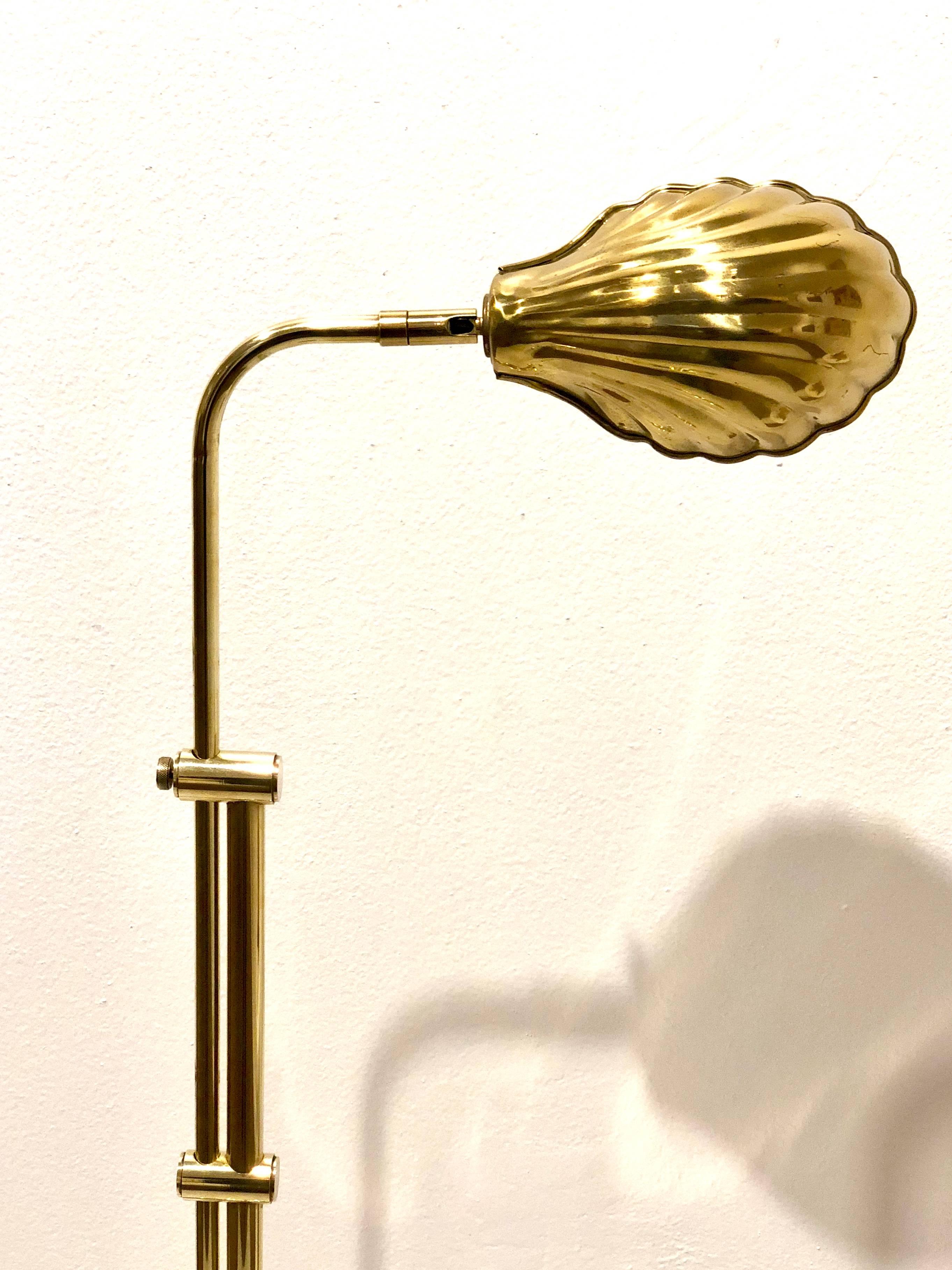 Beautifully design adjustable polished brass floor lamp with tilt and swivel, shell shade. A perfect addition to those living by the water or perhaps those who dream of a walk along the shore.