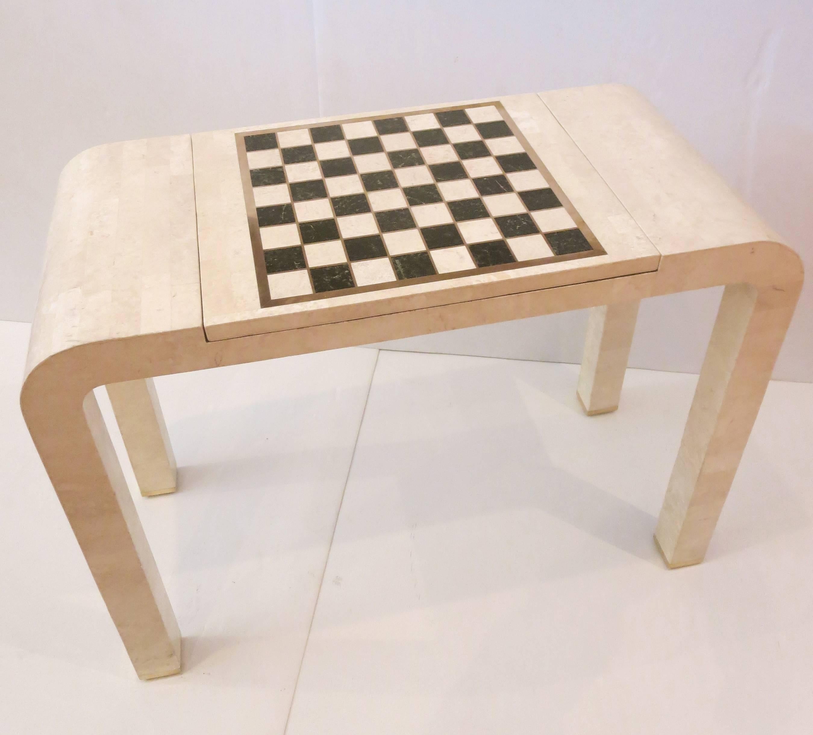 Beautiful and unique console table by Maitland Smith circa 1980s in tessellated stone with brass inlay accents. The table top is a removable checkerboard with a backgammon board underneath and can also be used on the blank side.