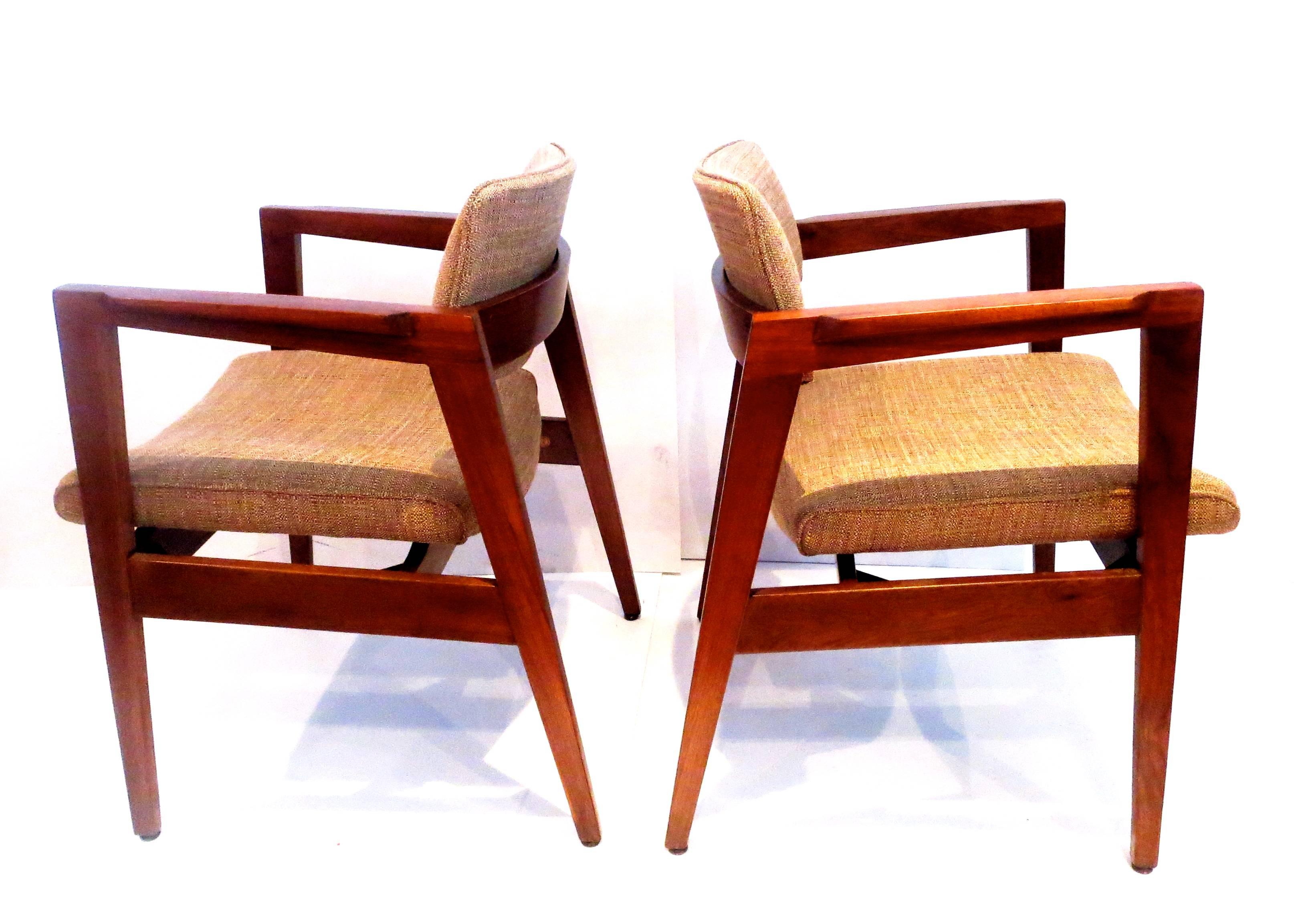 Striking elegant 1950s solid walnut frame armchairs by Gunlocke Chair Company, the chairs have been refinished and recover in brown fabric, solid and sturdy great lines.