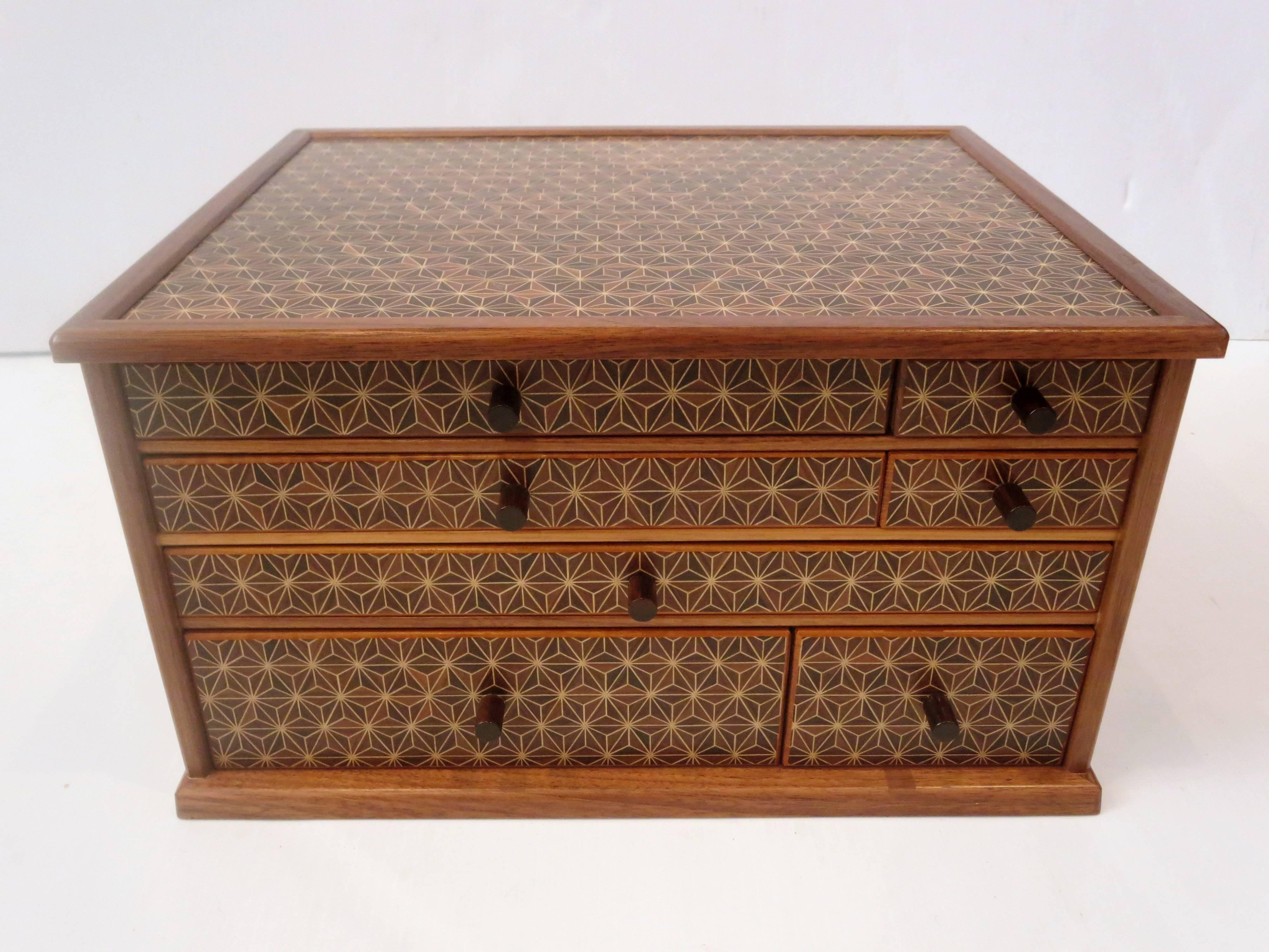 A very rare and unique Japanese jewelry box with multiple compartments. Beautiful geometric pattern with rosewood handles. Drawers can be rearranged for different configurations. All handmade, beautiful construction. Very nice condition on this