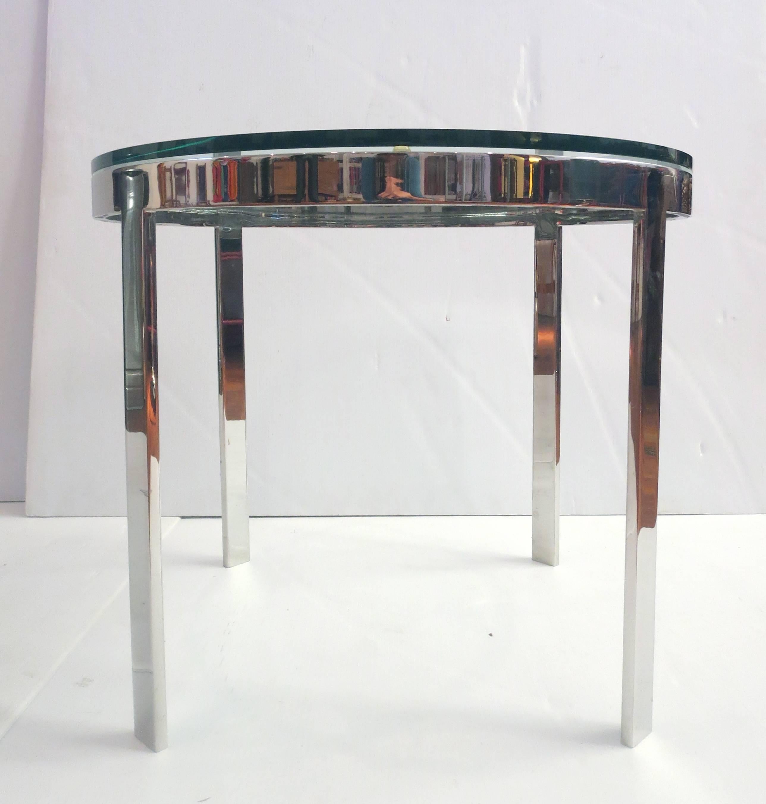 A very unique solid polished steel with thick glass round top cocktail table by Nicos Zographos circa 1970s. This fine quality table is very heavy because it is solid steel. In very nice condition. The glass shows no cracks or chips.