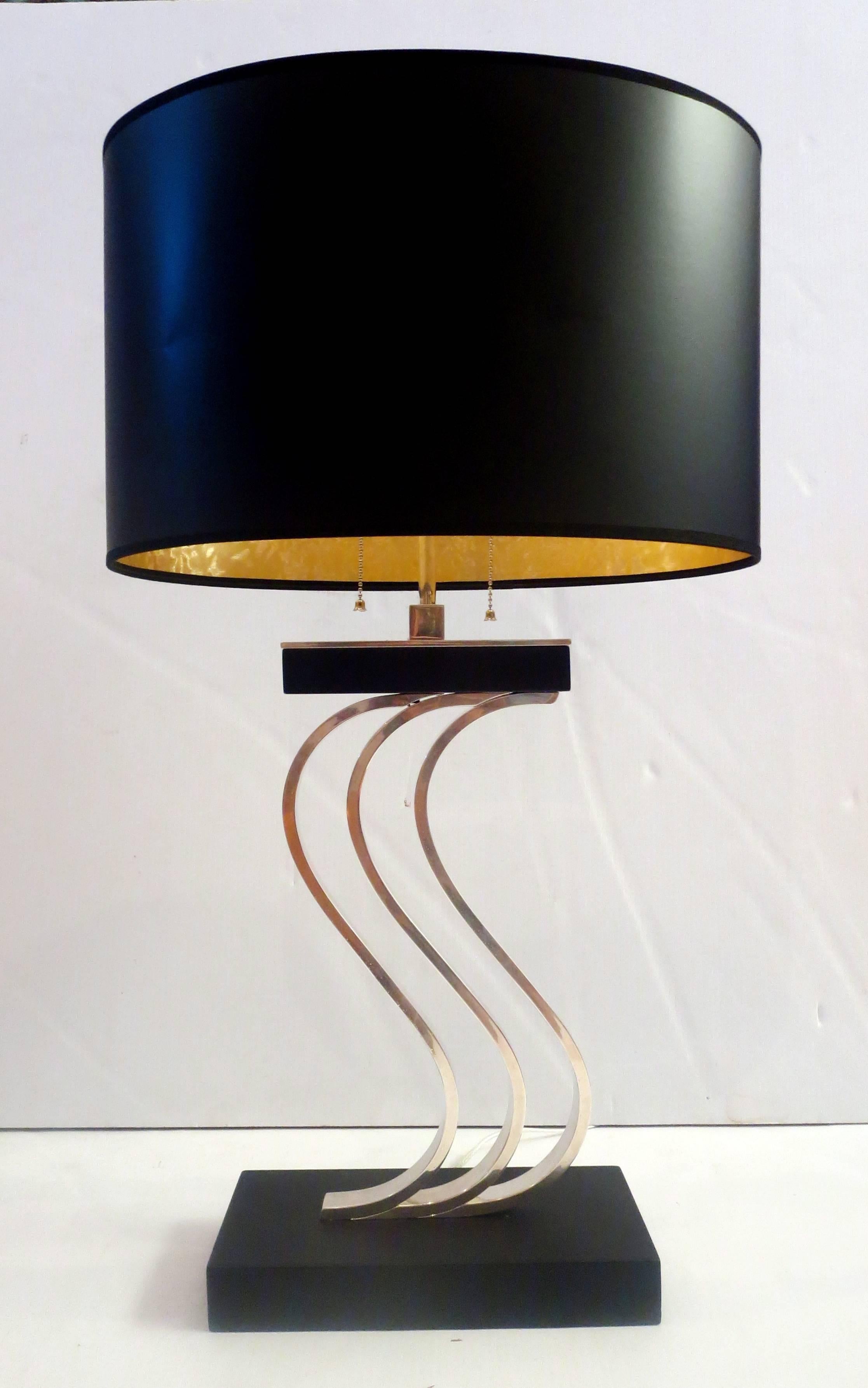 This is an incredible and unique lamp in the style of Donald Deskey. Circa 1940s. This lamp has been completely restored to almost new condition. The lamp has been rewired, the base is black lacquer and the three center pieces, the top pieces and