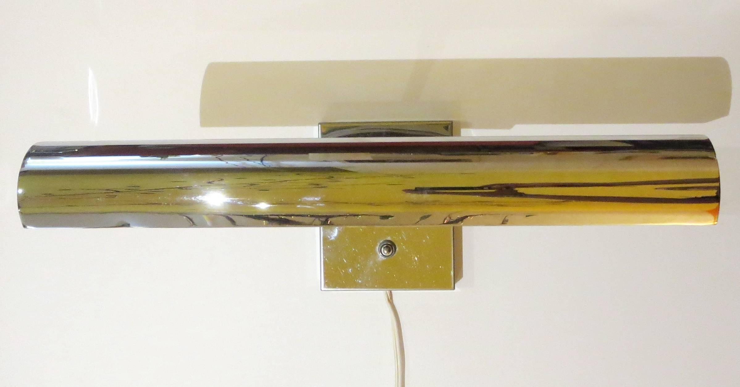 Rare hard to find double head wall sconce multidirectional shade moves up & down and side to side , perfect to place above a bed or also on top of a painting , great condition polished chrome no rust or scratches, can be hard wired or comes with a