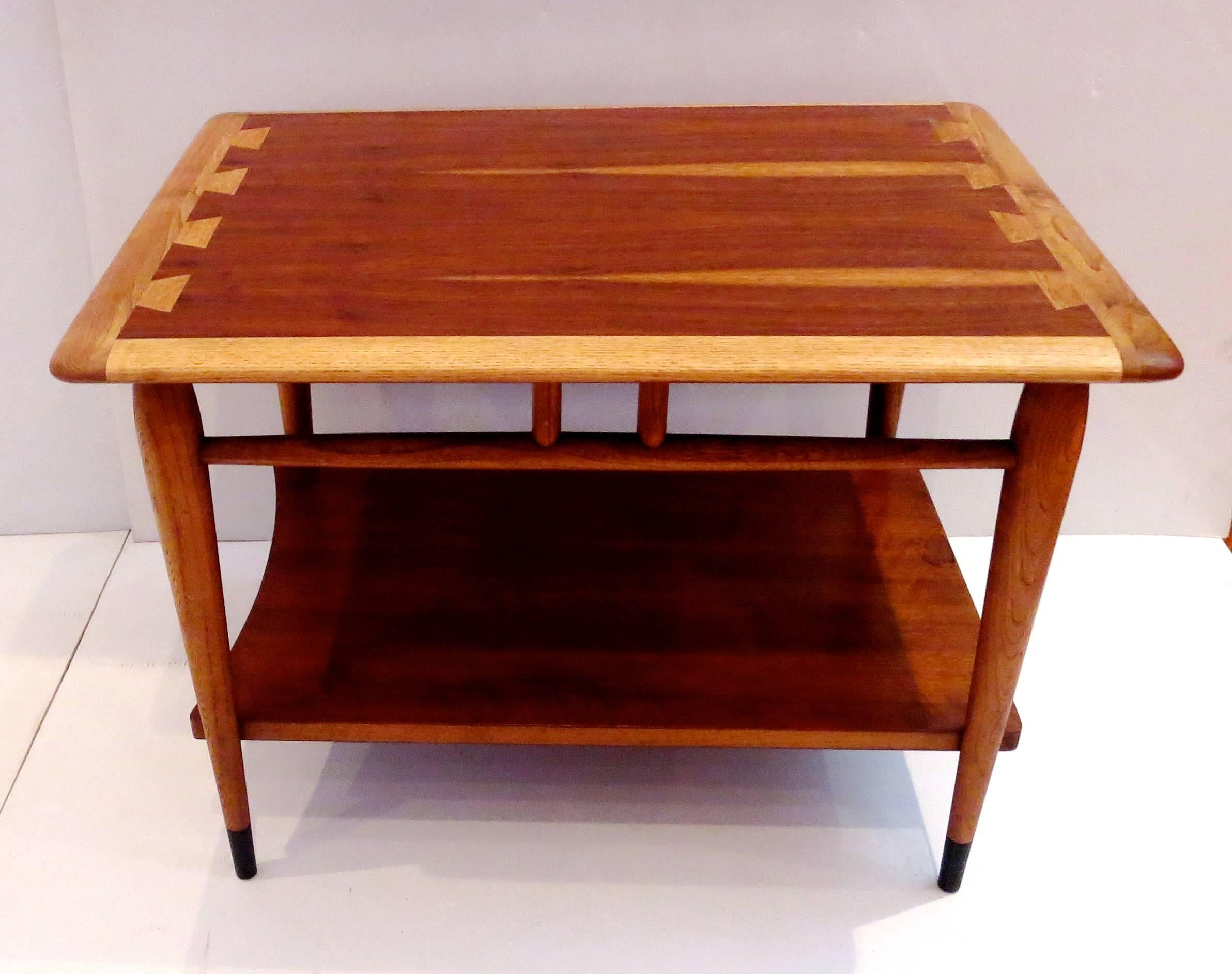 Beautiful craftsmanship on this 1950s, American modern walnut inlaid end table, solid tapered legs with black lacquered end tips, and beech wood combination, the table is in great condition, totally refinished. Great between two club chairs or can