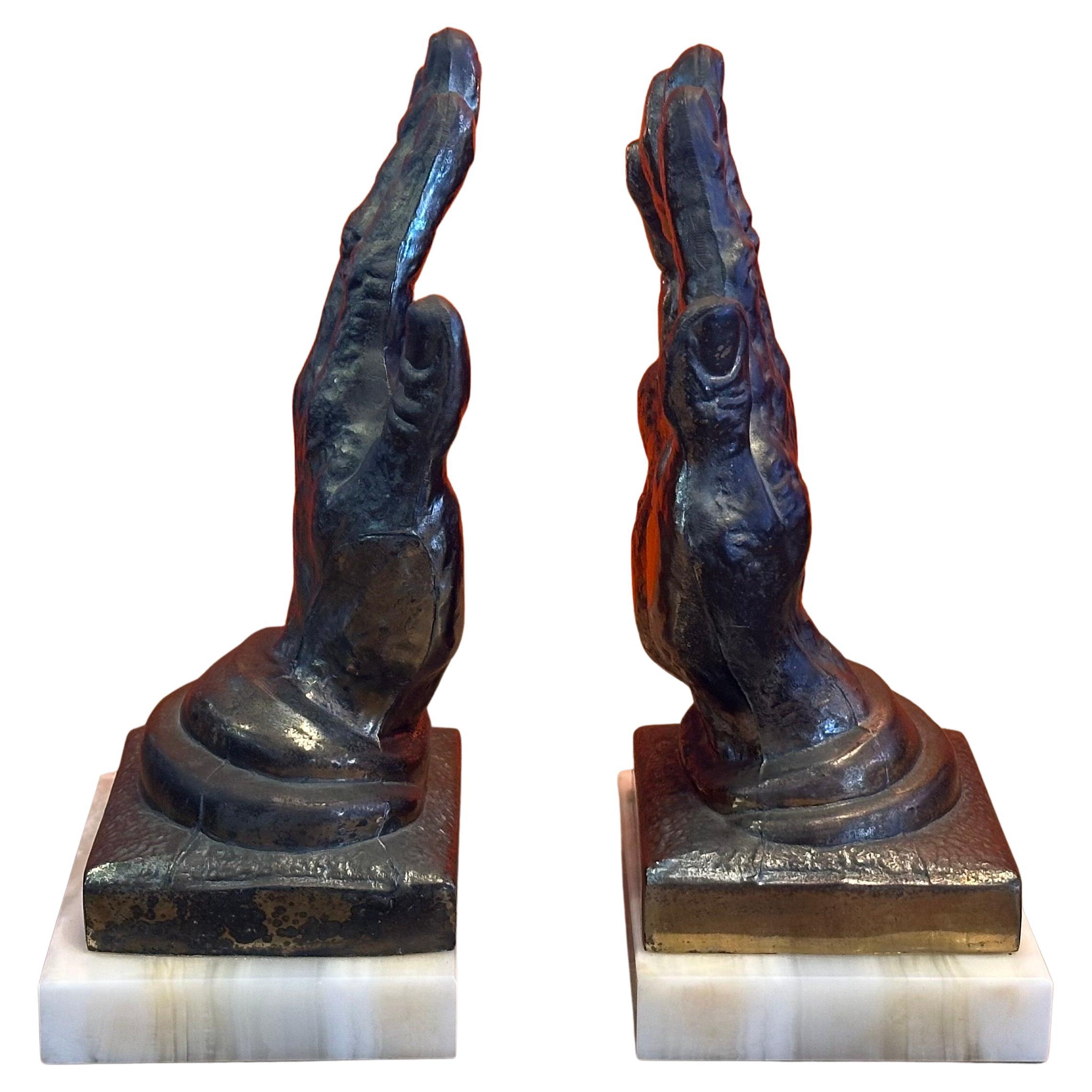 Coppia di reggilibri d
epoca in ottone "mani oranti" su onice