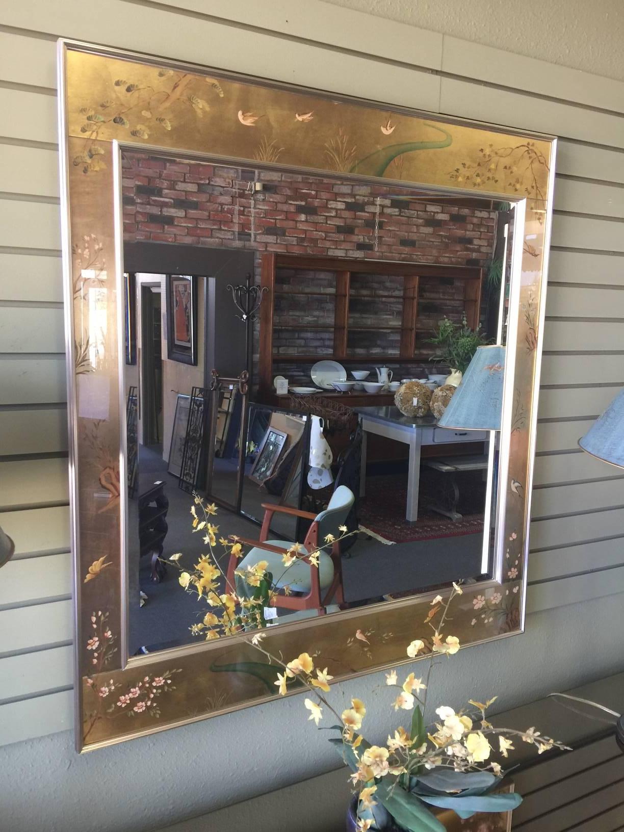 Stunning reverse hand-painted églomisé beveled mirror in a chinoiserie style. Hand signed in lower right corner by artist D. Wingard and dated '77. This gorgeous piece is made by Labarge, one of the worlds premiere manufacturer of mirrors.