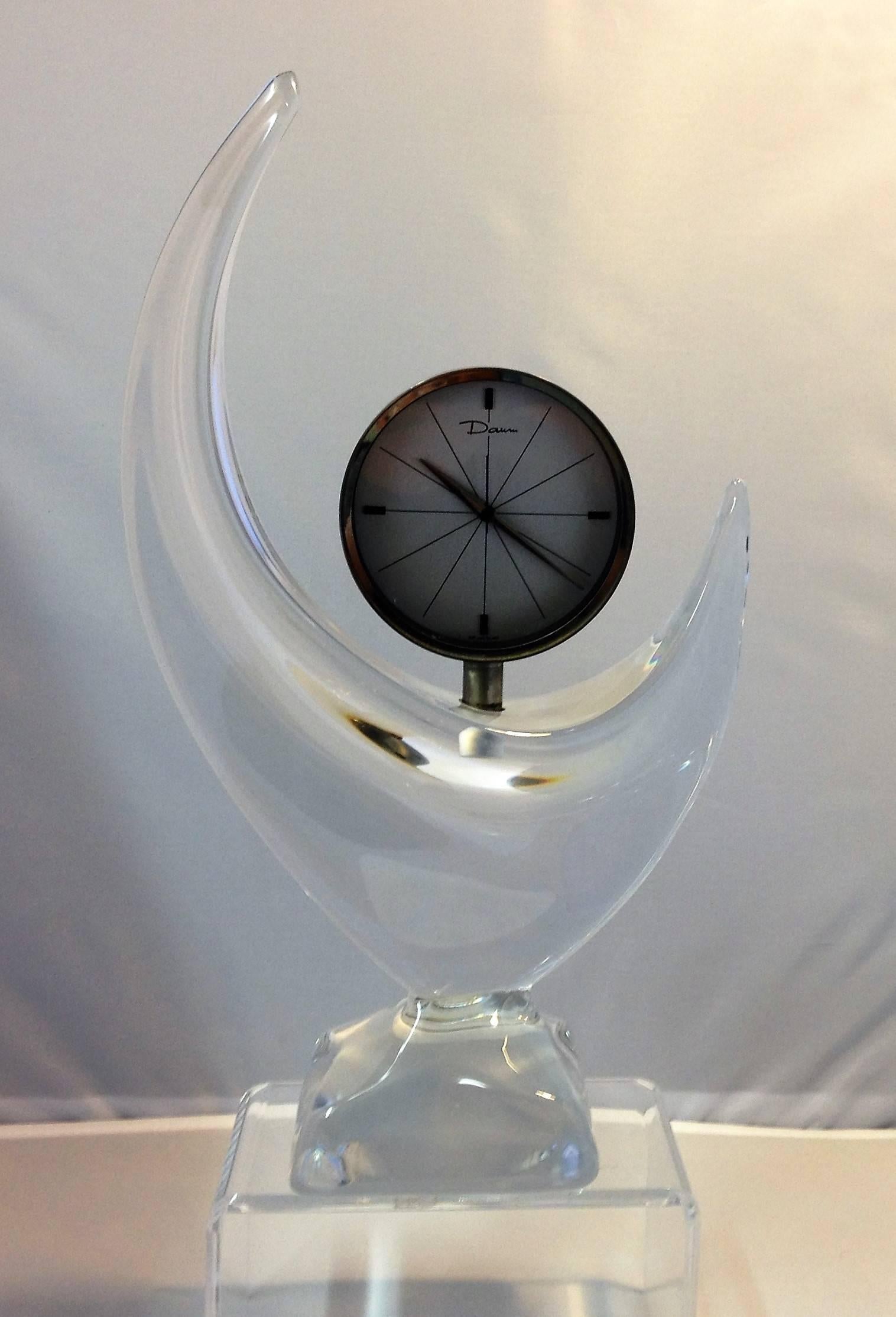 Striking crescent moon shaped, crystal mantel clock by Daum. This rare Mid-Century piece is in excellent working condition and makes an elegant statement in any room.