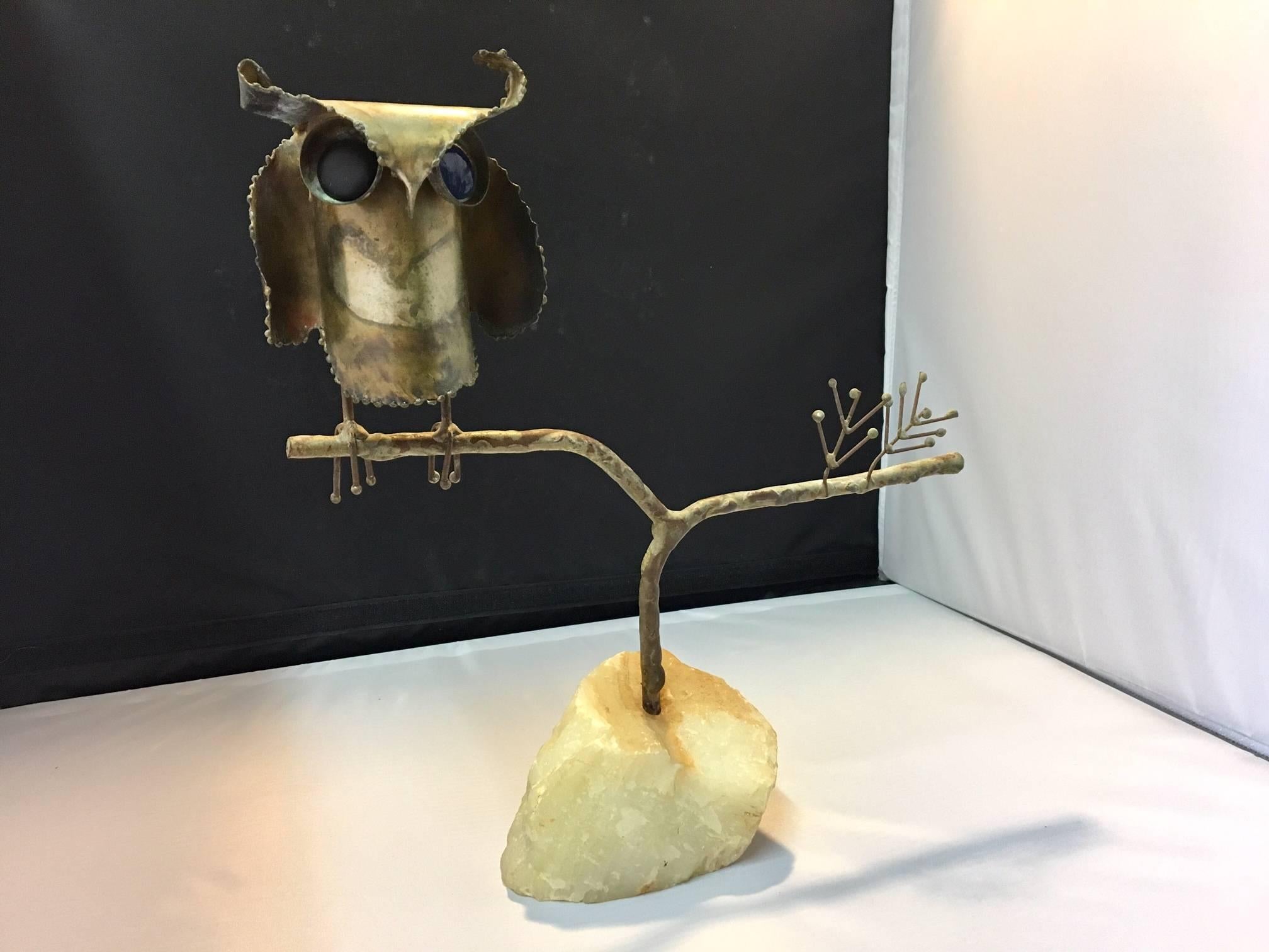 Whimsical table sculpture signed and dated by Curtis Jere. The owl is sitting on a marble base and has one black and one blue enamel eye. This is a very collectible item, signed C. Jere and dated 1968.