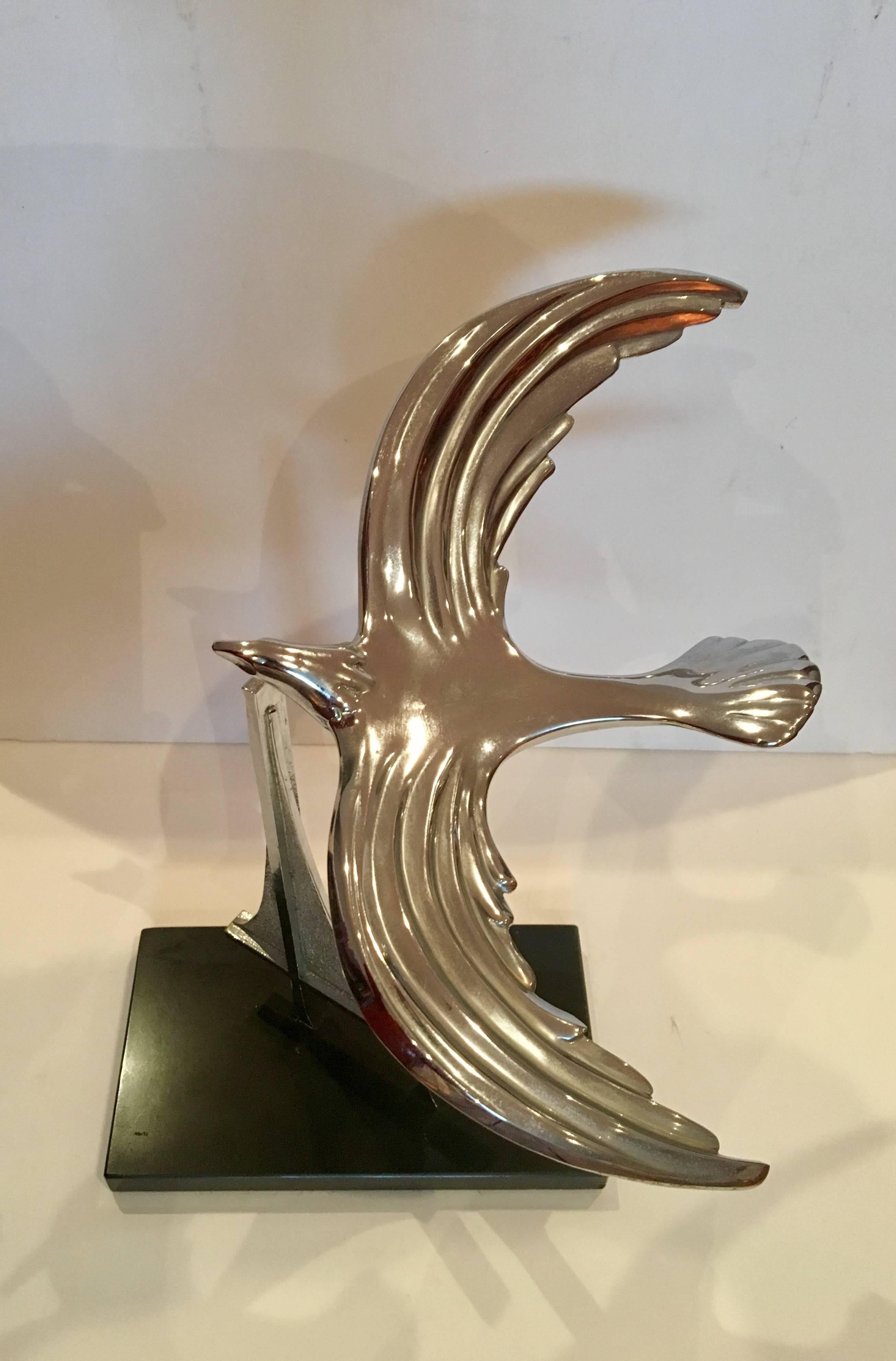 Nice sculpture by M K Shannon, engraved at the bottom by the artist dated 1986 and numbered 293/350, in chrome finish sitting on black marble base.